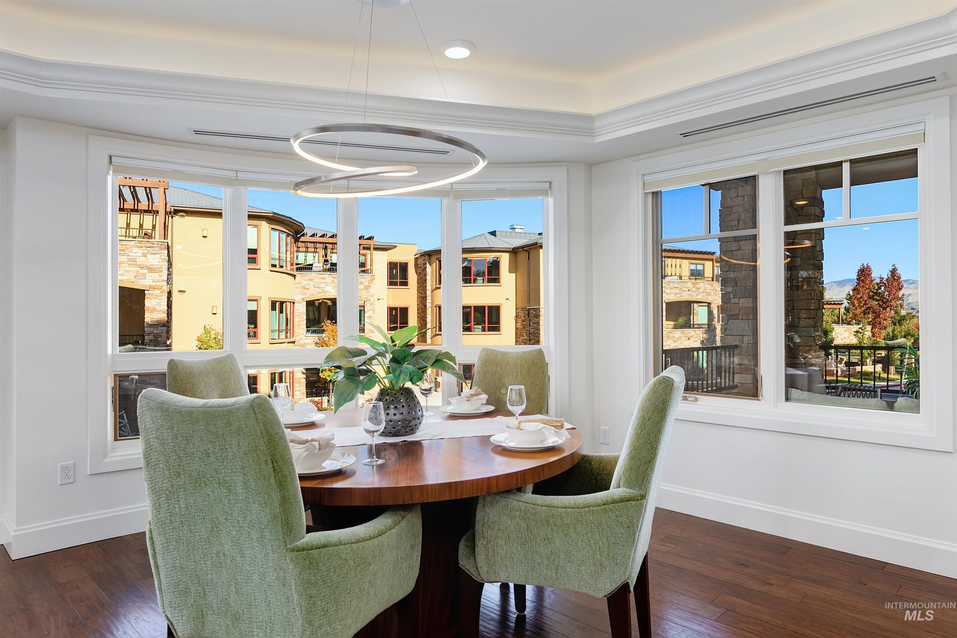 Dining area featuring dark wood-style floors and baseboards