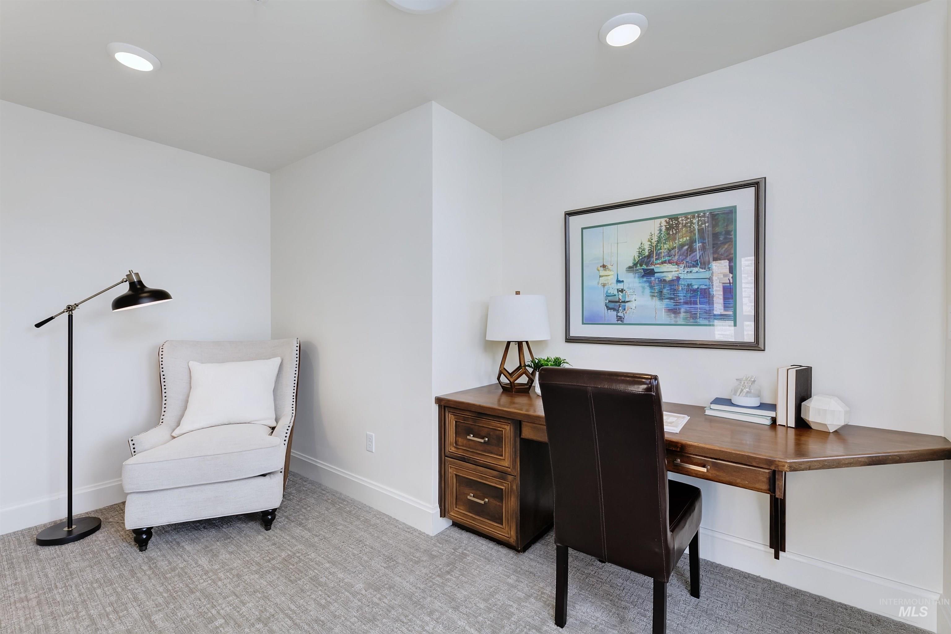 Office area with light carpet and recessed lighting