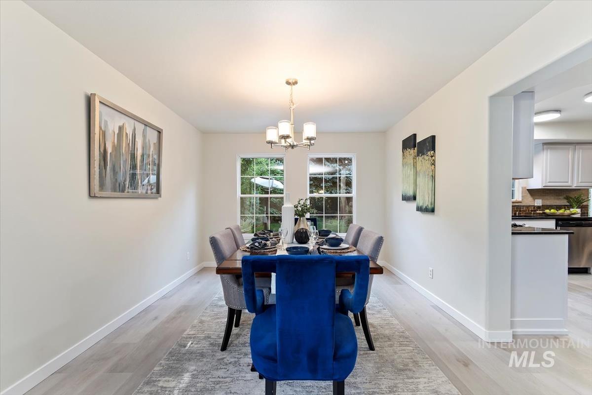 Dining space featuring a chandelier and light wood-style flooring