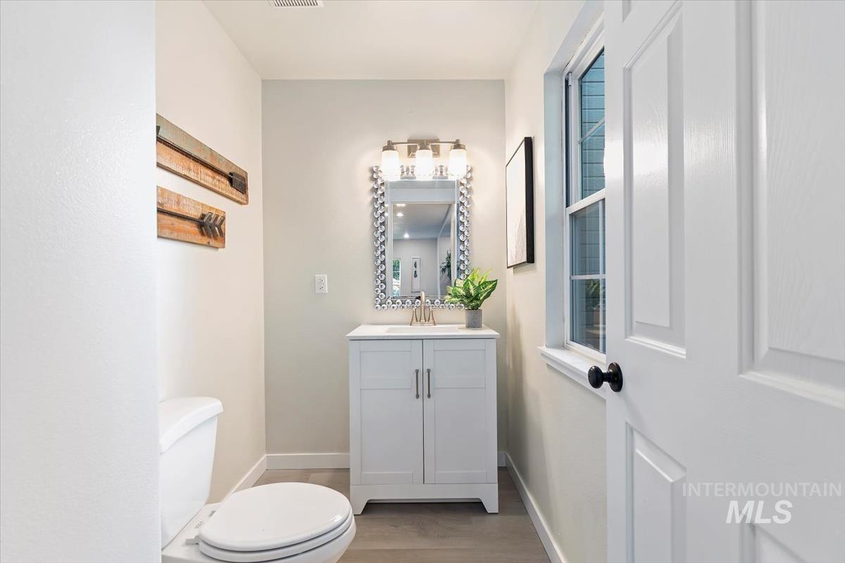 Bathroom featuring vanity and wood finished floors