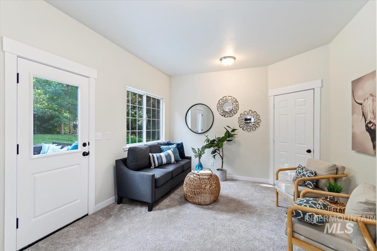 Sitting room featuring carpet flooring and baseboards