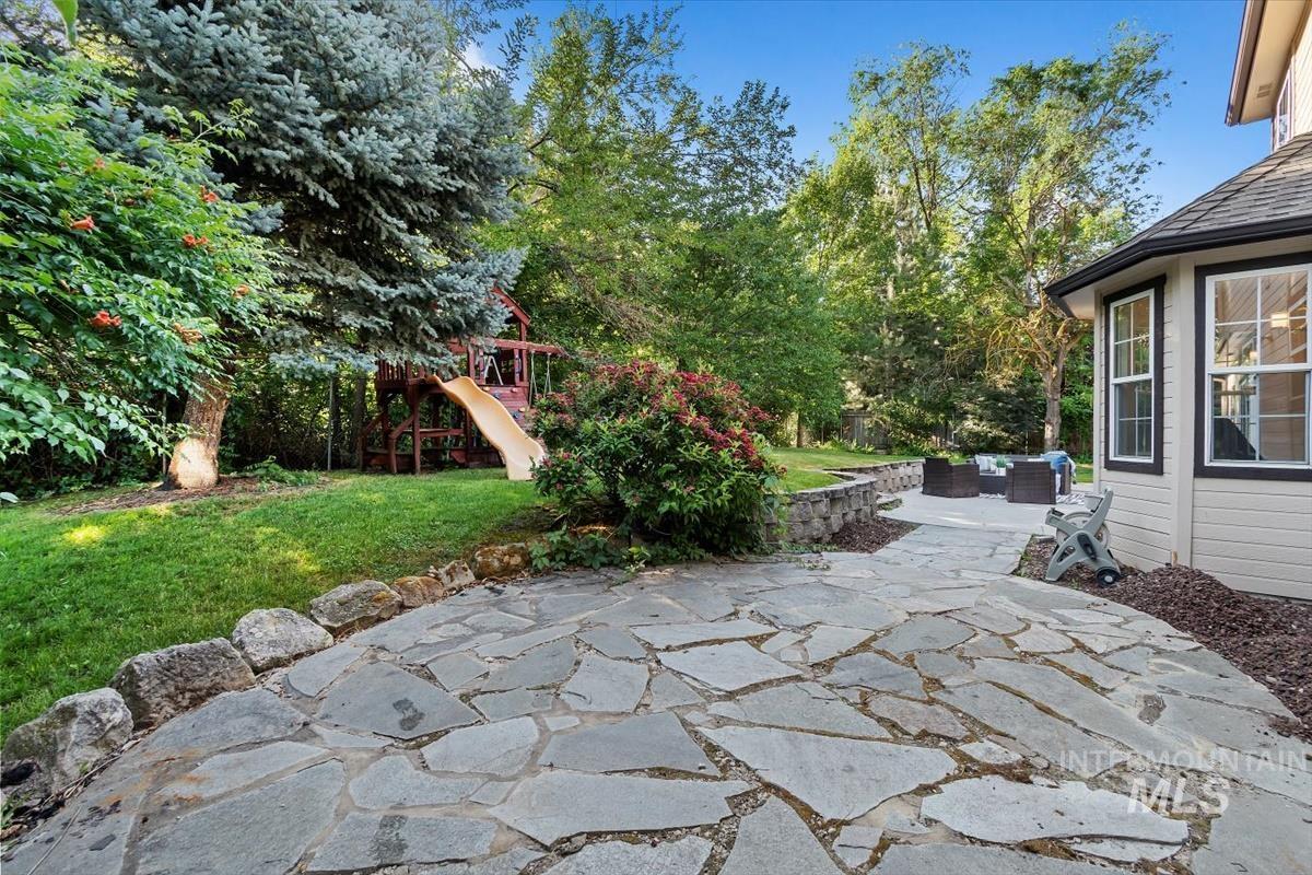 View of patio with an outdoor hangout area and a playground