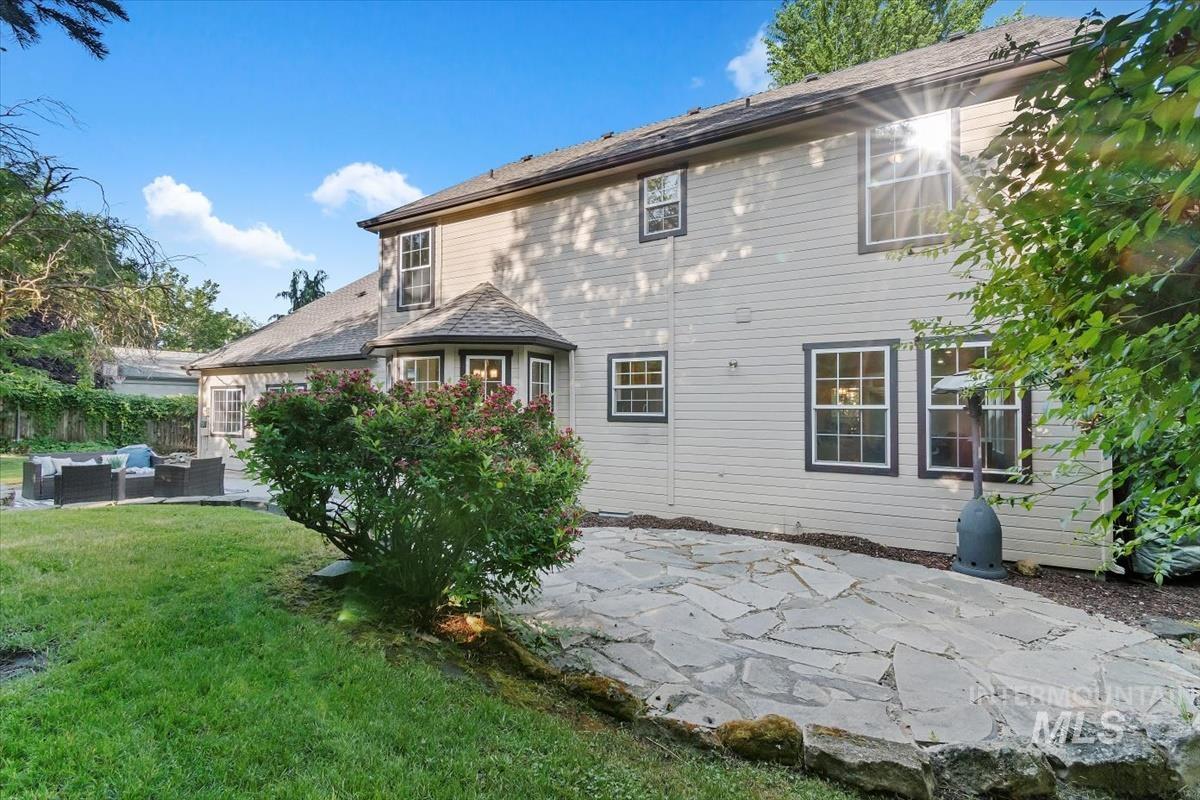 Back of house with an outdoor living space and a patio area