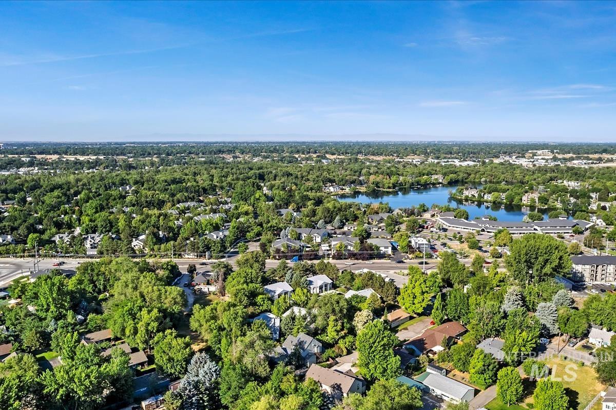 Aerial view of property's location featuring a large body of water and nearby suburban area