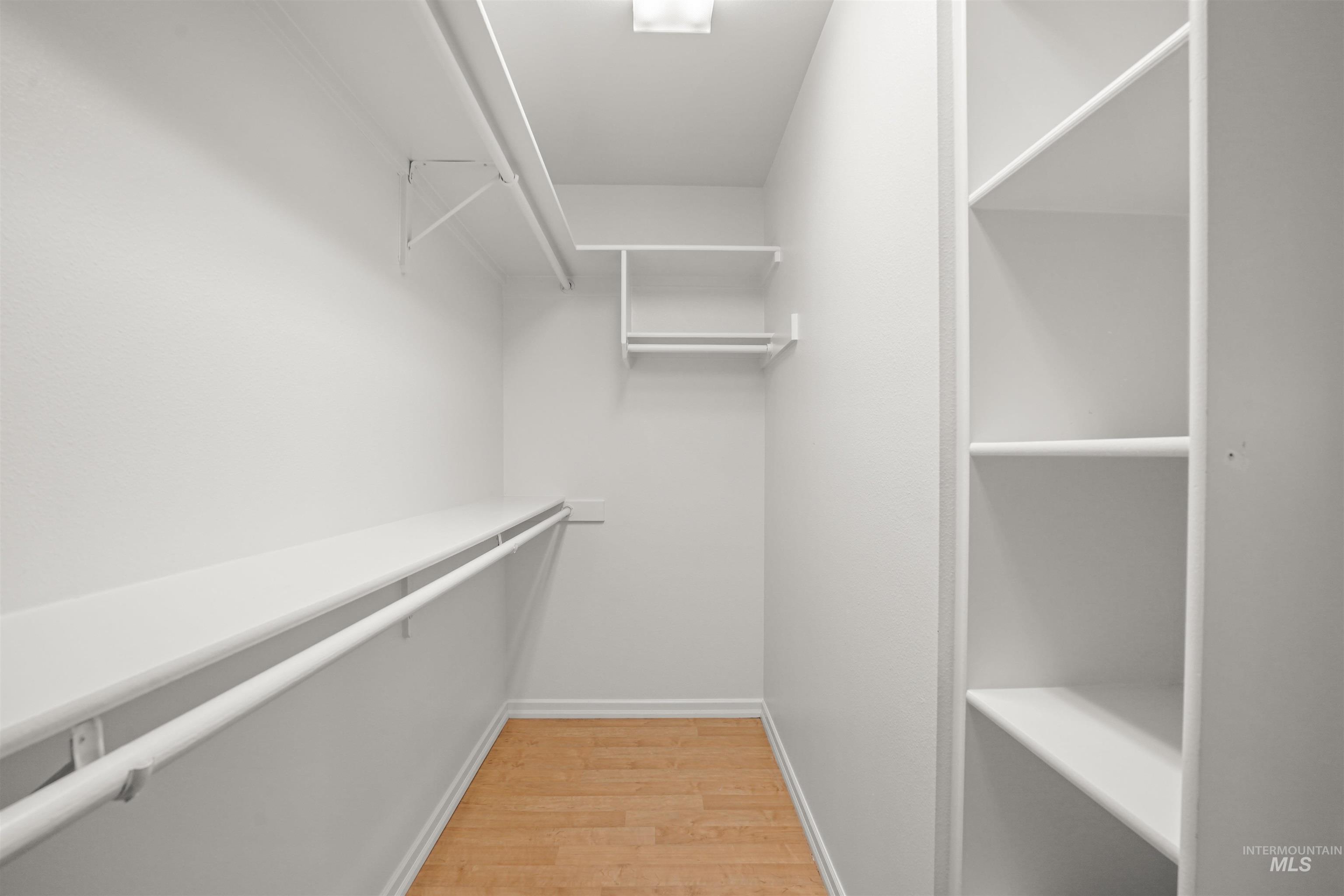 Spacious closet with light wood-type flooring