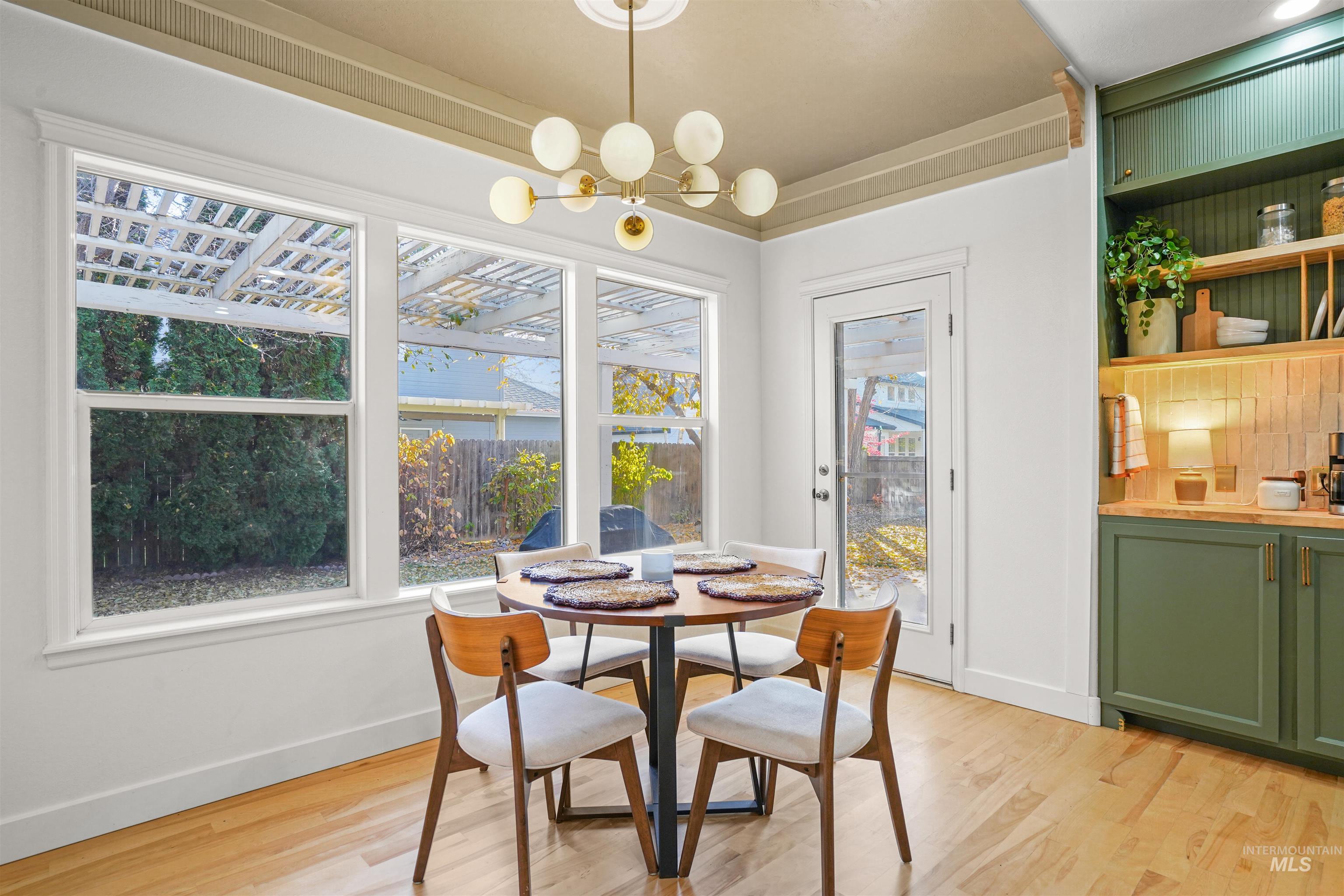 Dining area featuring light wood finished floors and a chandelier