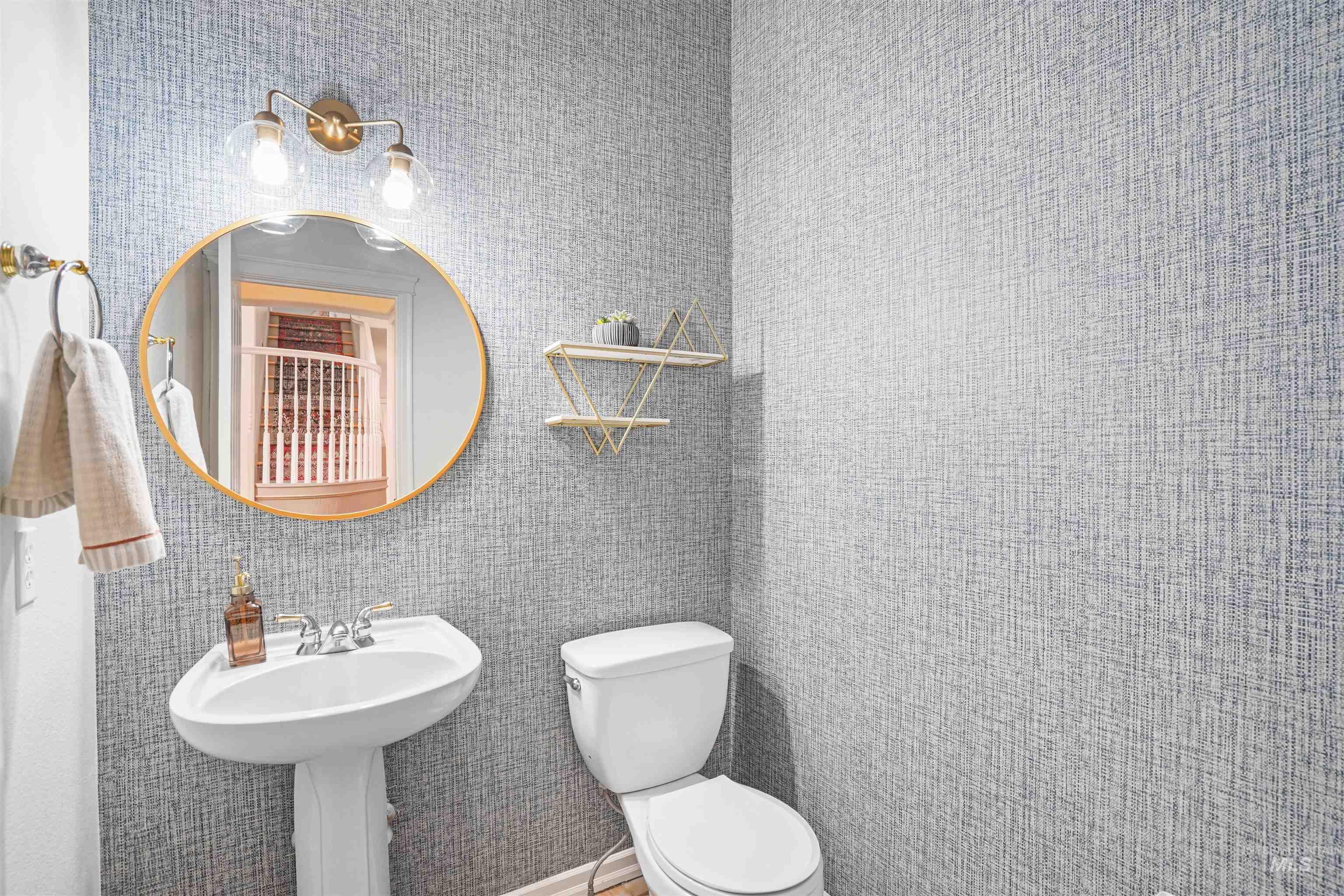Half bathroom featuring toilet and tile walls