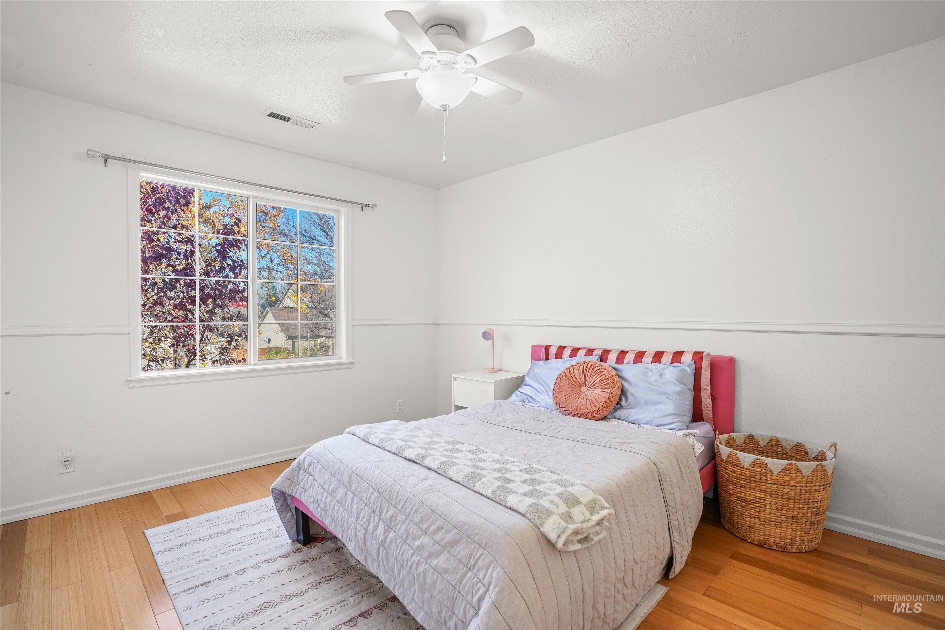 Bedroom featuring light wood-type flooring and a ceiling fan