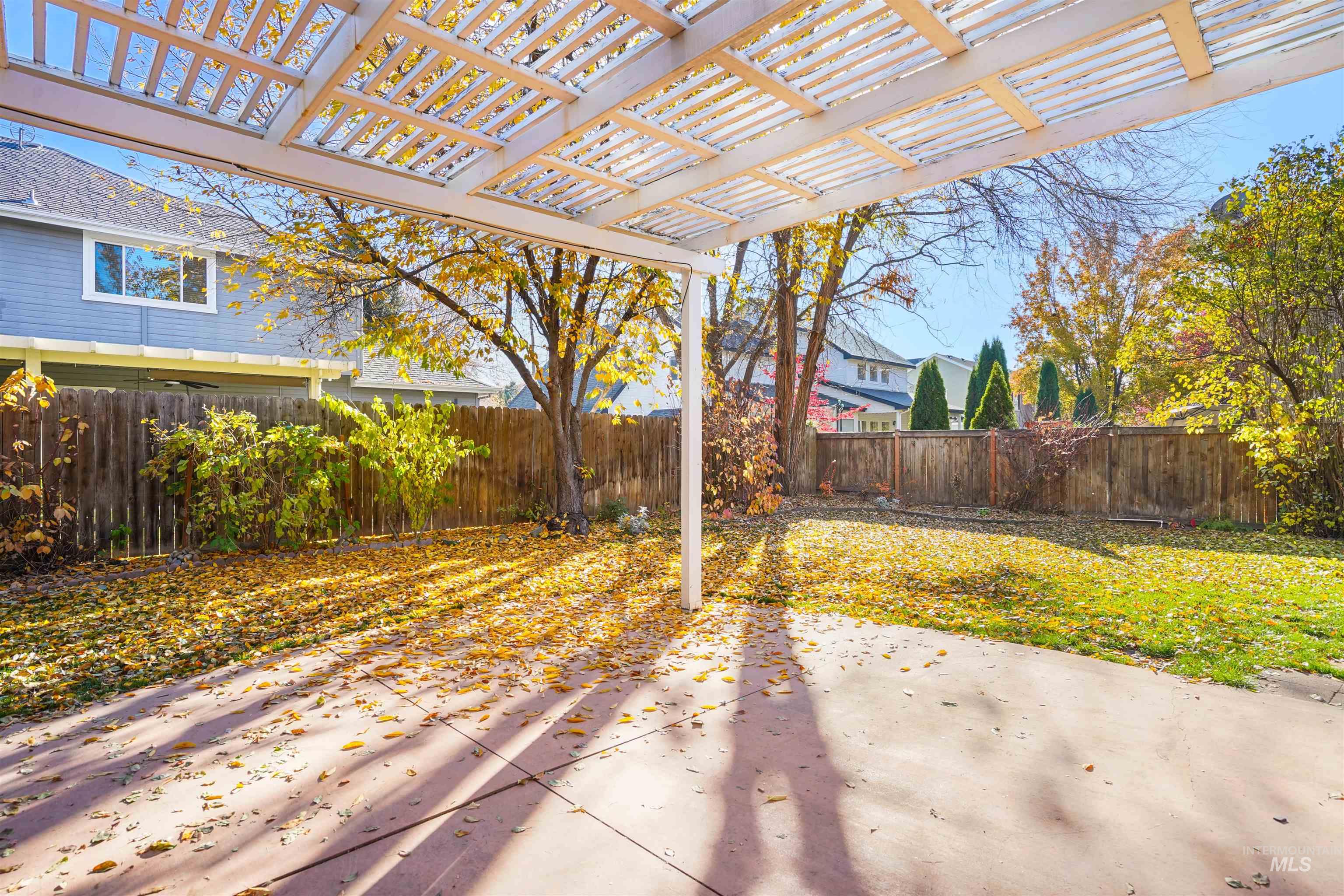 Fenced backyard with a pergola