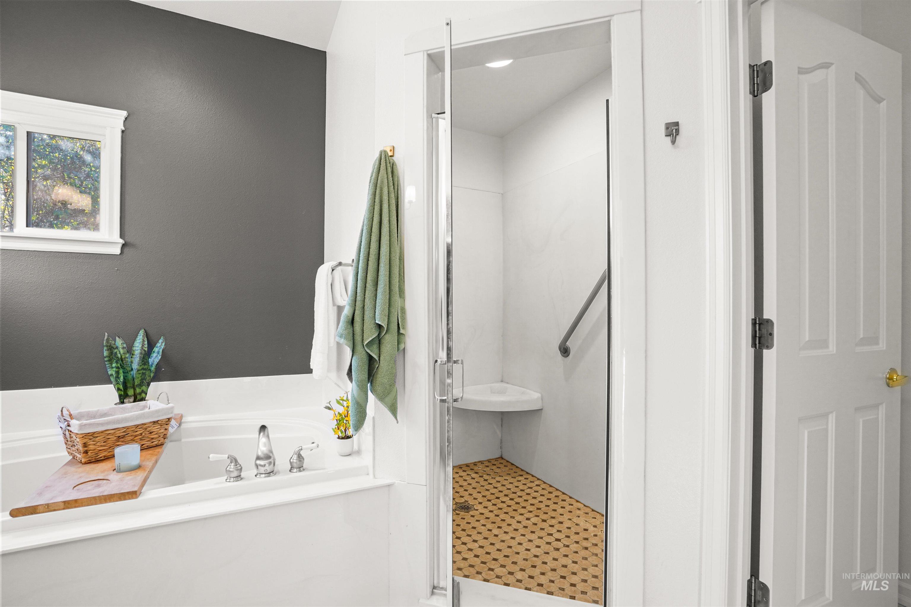 Full bath with a stall shower and a garden tub