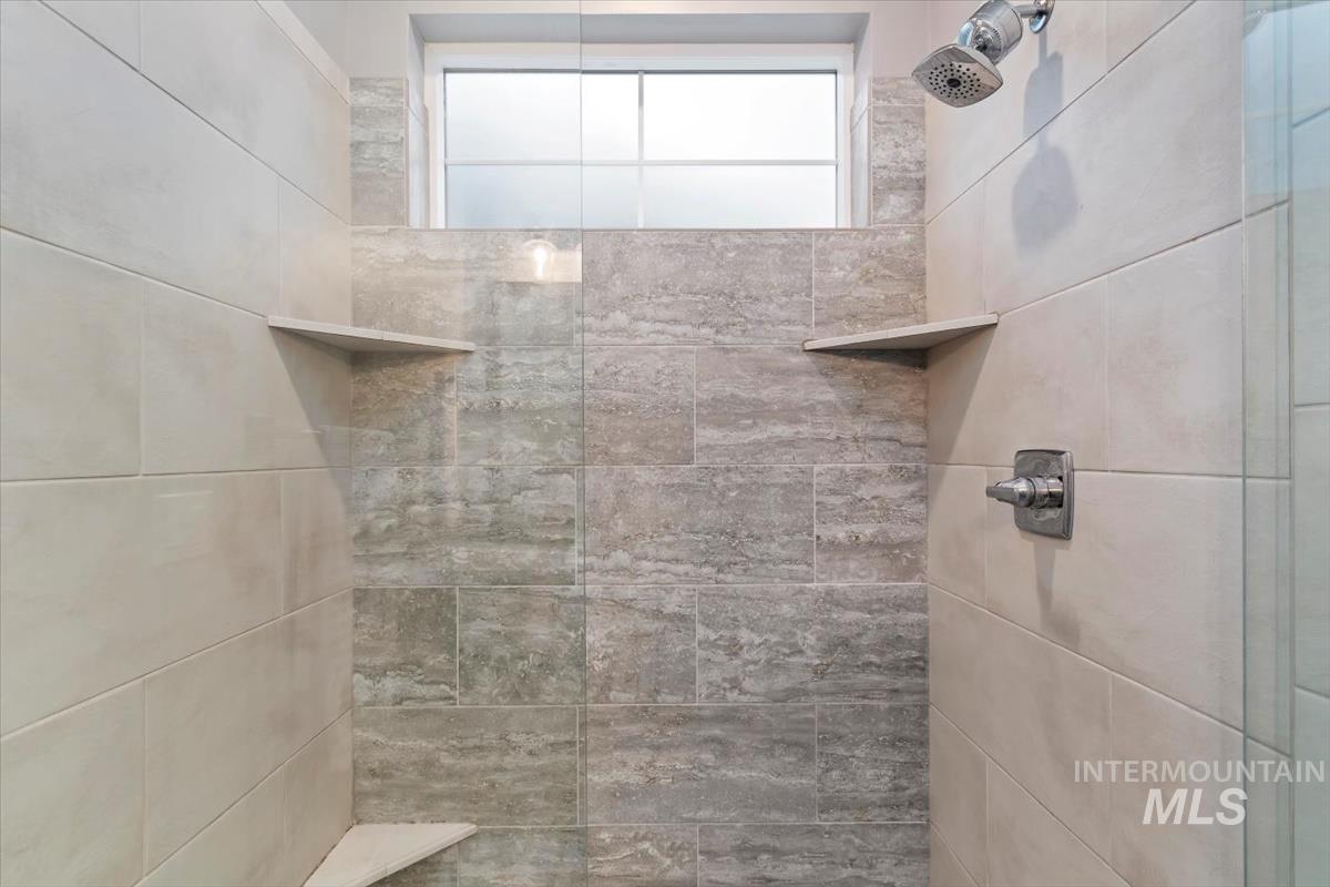 Full bathroom featuring tiled shower