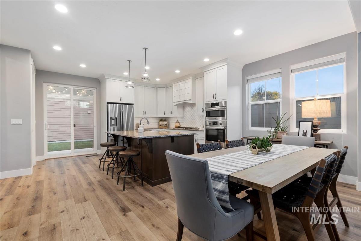 Dining room featuring light wood-style floors and recessed lighting
