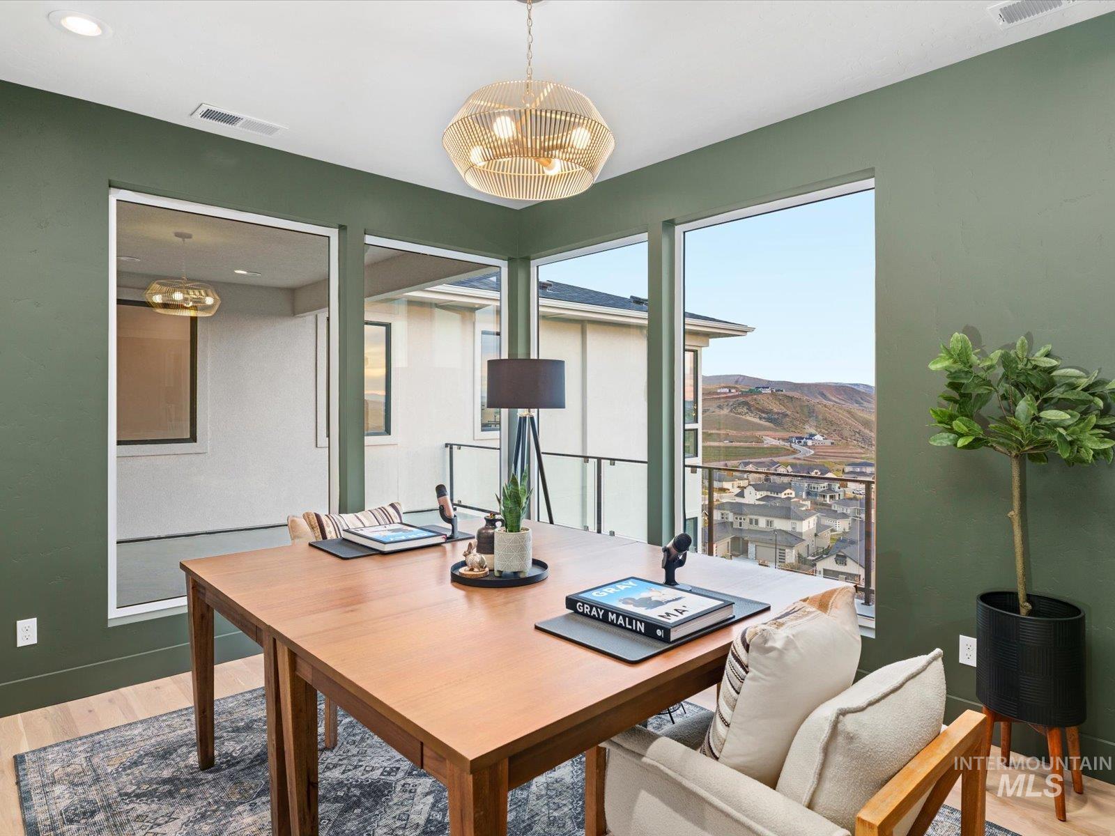 Office space featuring light wood-style floors and a chandelier