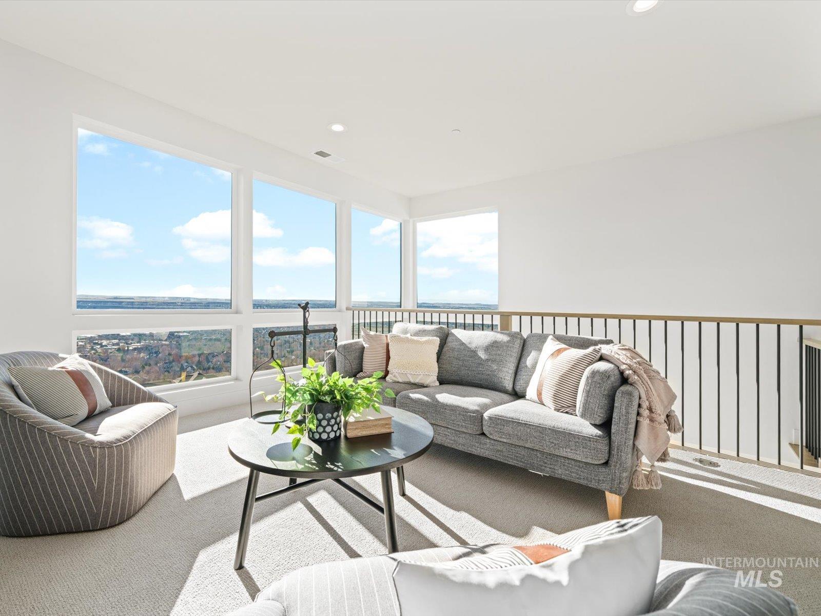 Living area with carpet, a water view, and recessed lighting