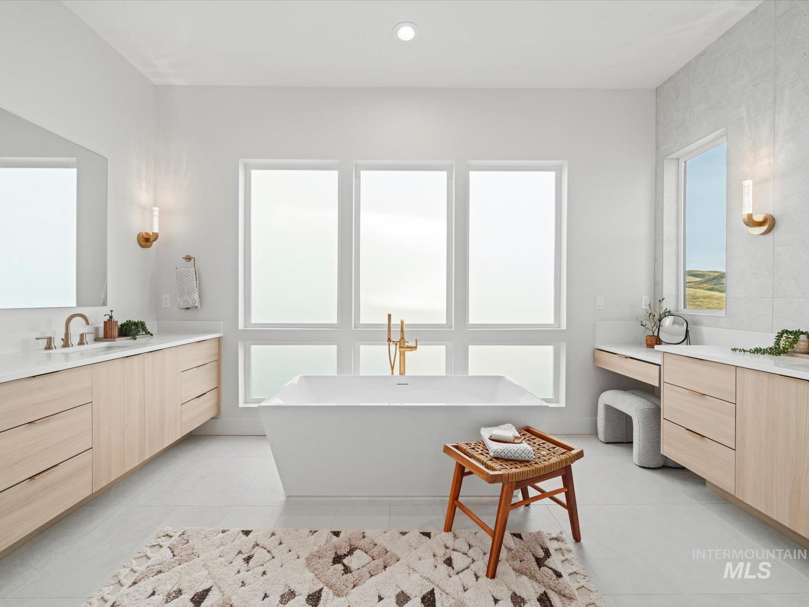Bathroom with vanity, a freestanding tub, light tile patterned floors, and recessed lighting