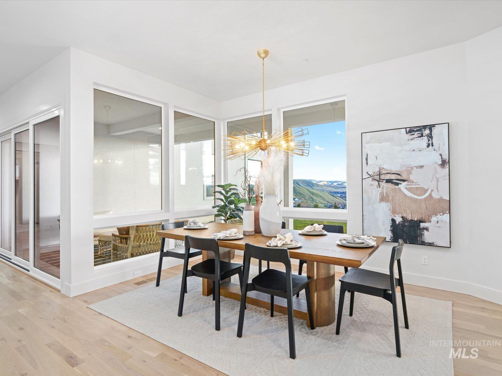 Dining room with light wood finished floors and a chandelier
