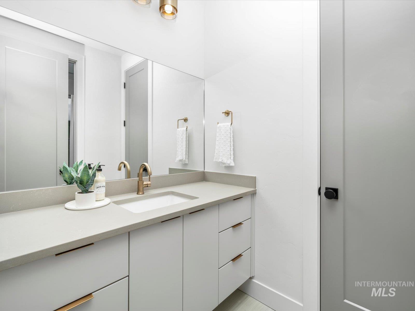 Bathroom with vanity and baseboards