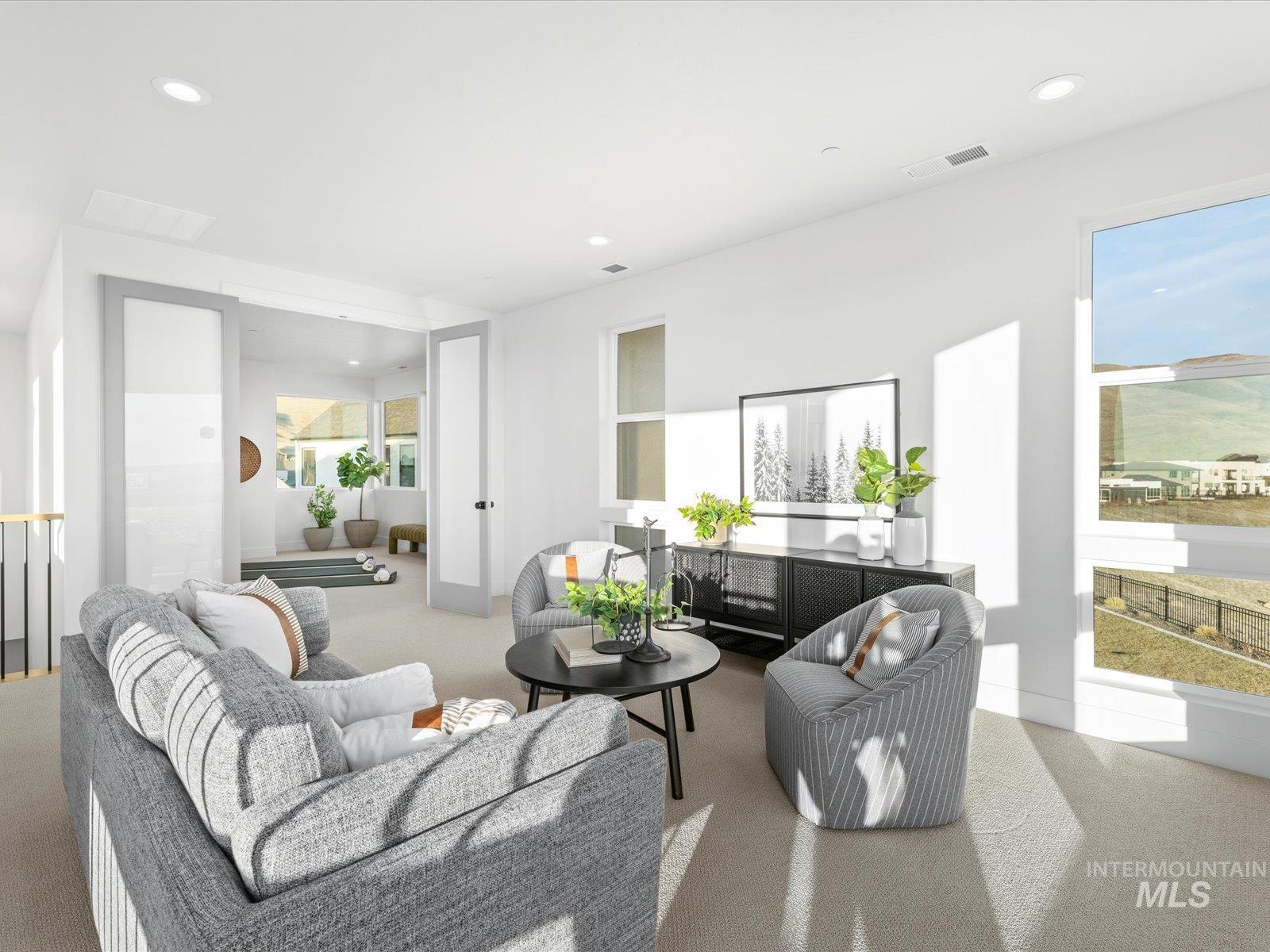 Carpeted living room with recessed lighting