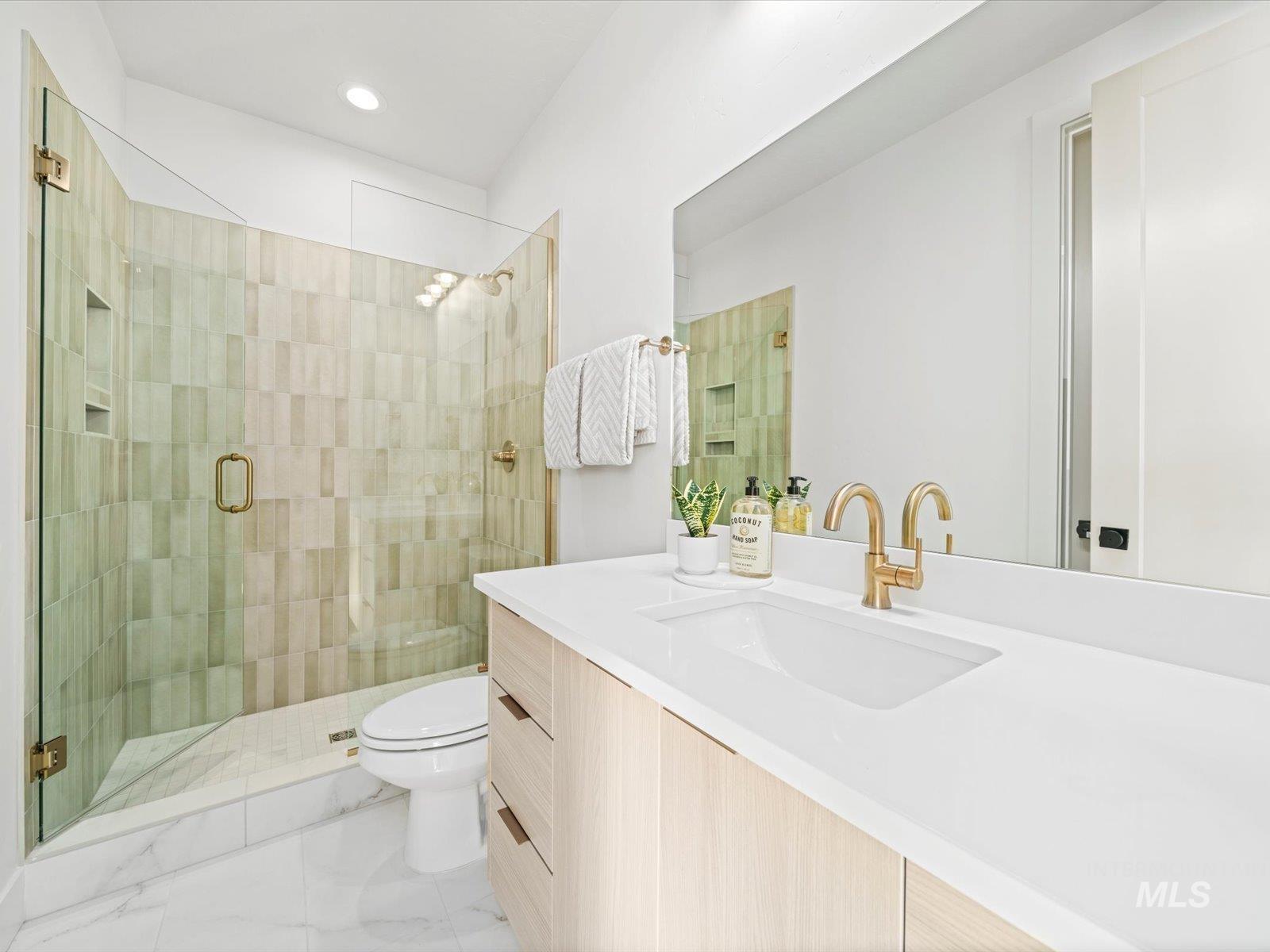 Bathroom with a stall shower, vanity, recessed lighting, and light marble finish flooring