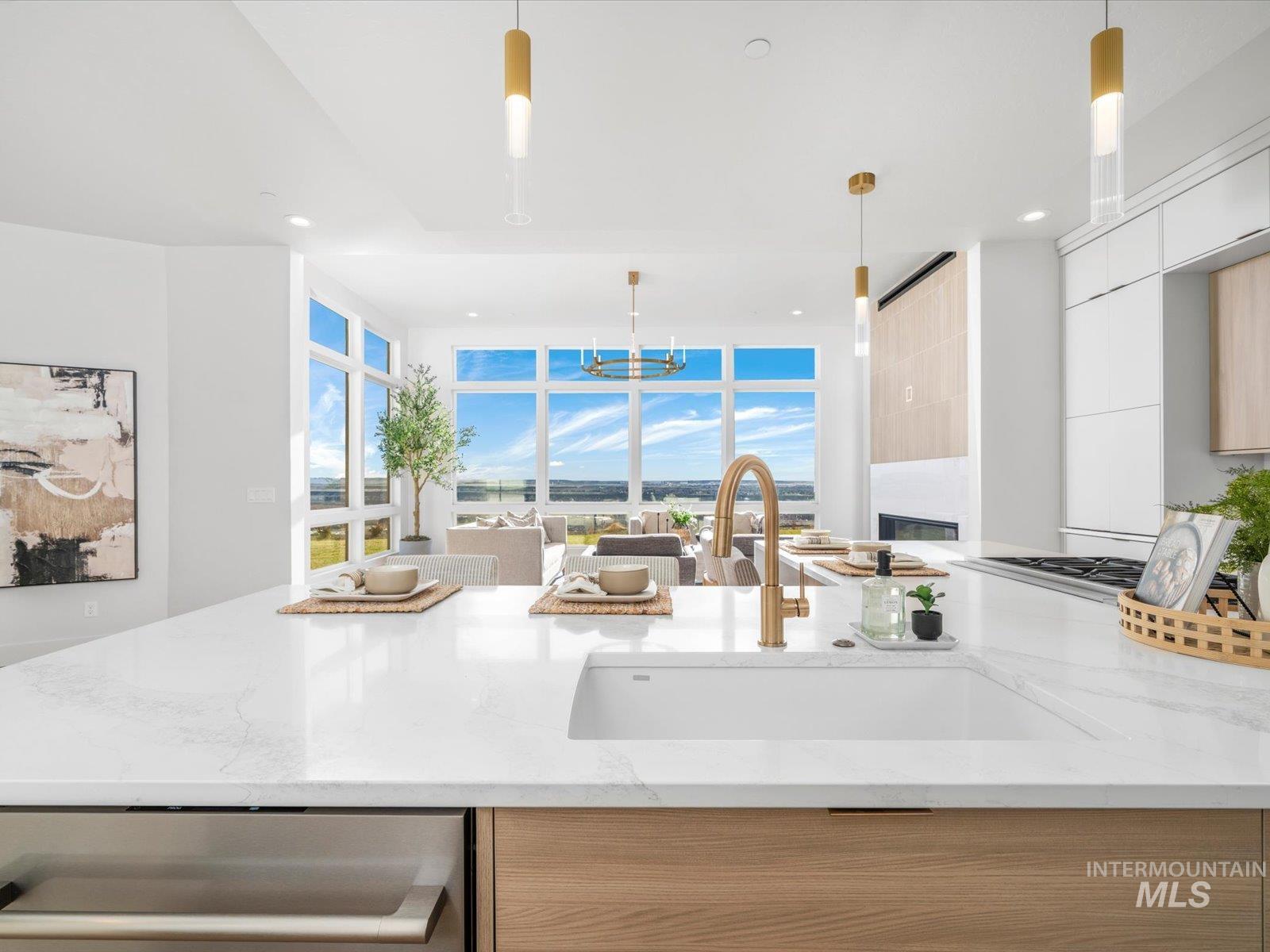 Kitchen featuring modern cabinets, light brown cabinetry, light stone countertops, healthy amount of natural light, and recessed lighting