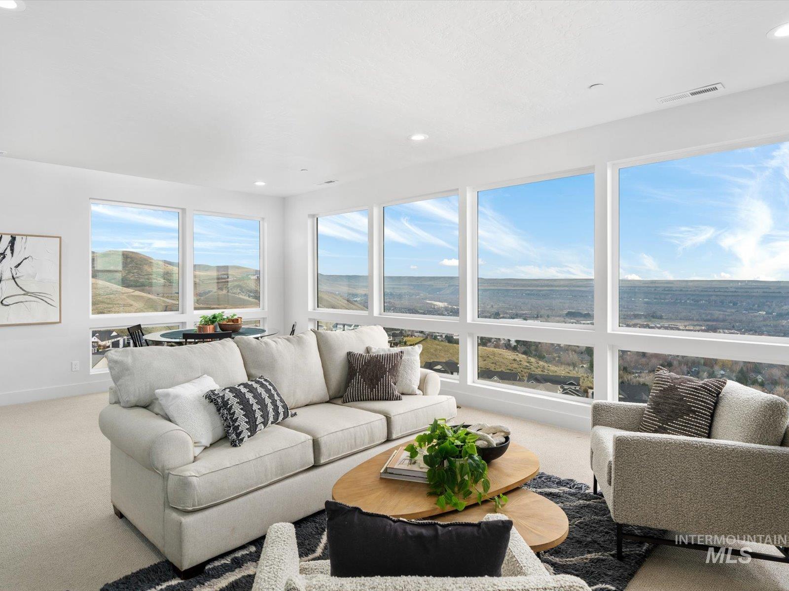 Sunroom with carpet floors and recessed lighting