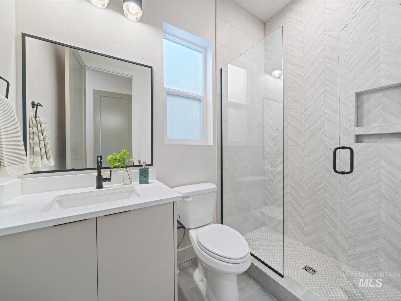 Full bathroom featuring vanity and a stall shower