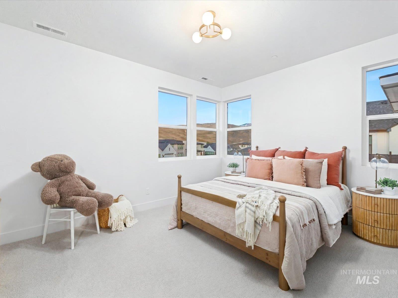 Bedroom featuring carpet floors and baseboards