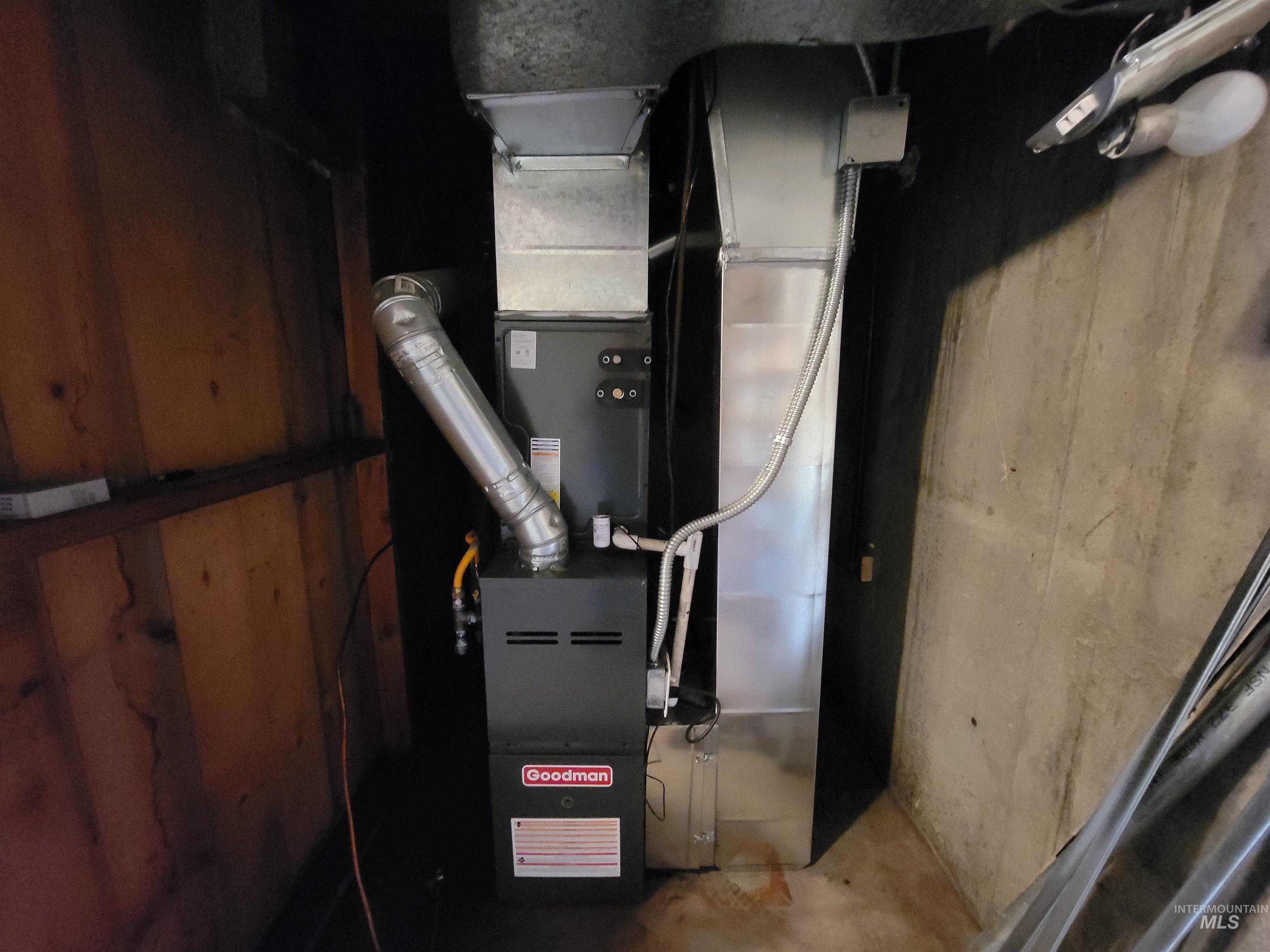 Utility room featuring heating unit