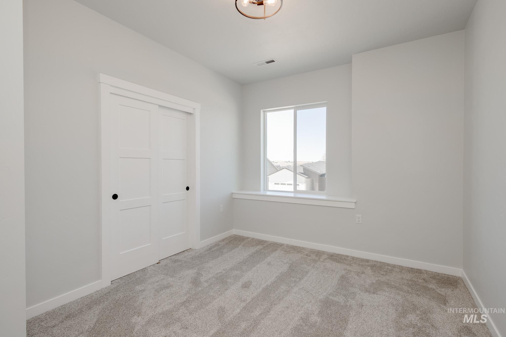 Unfurnished bedroom with carpet and a closet