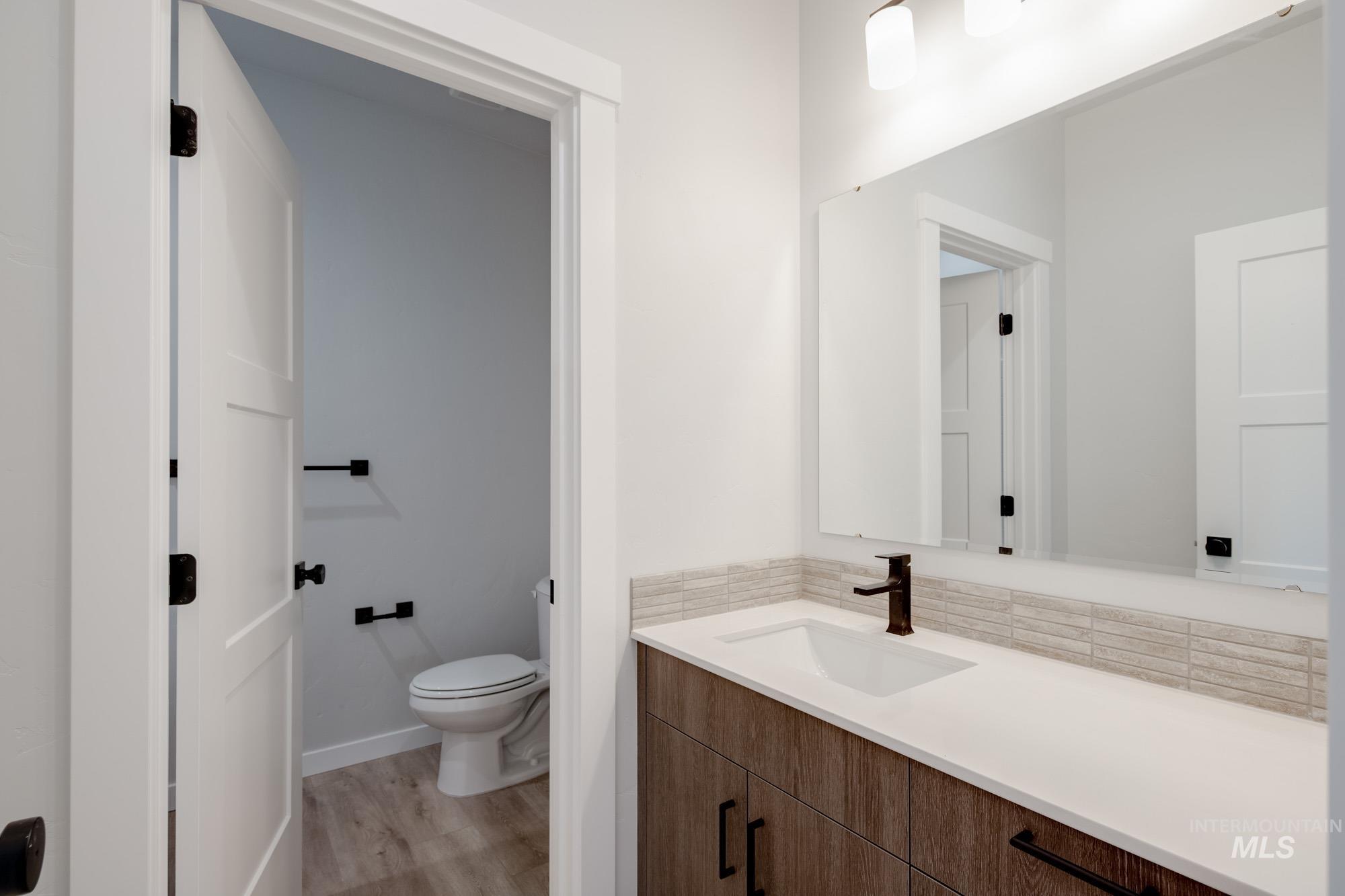 Bathroom with vanity and wood finished floors