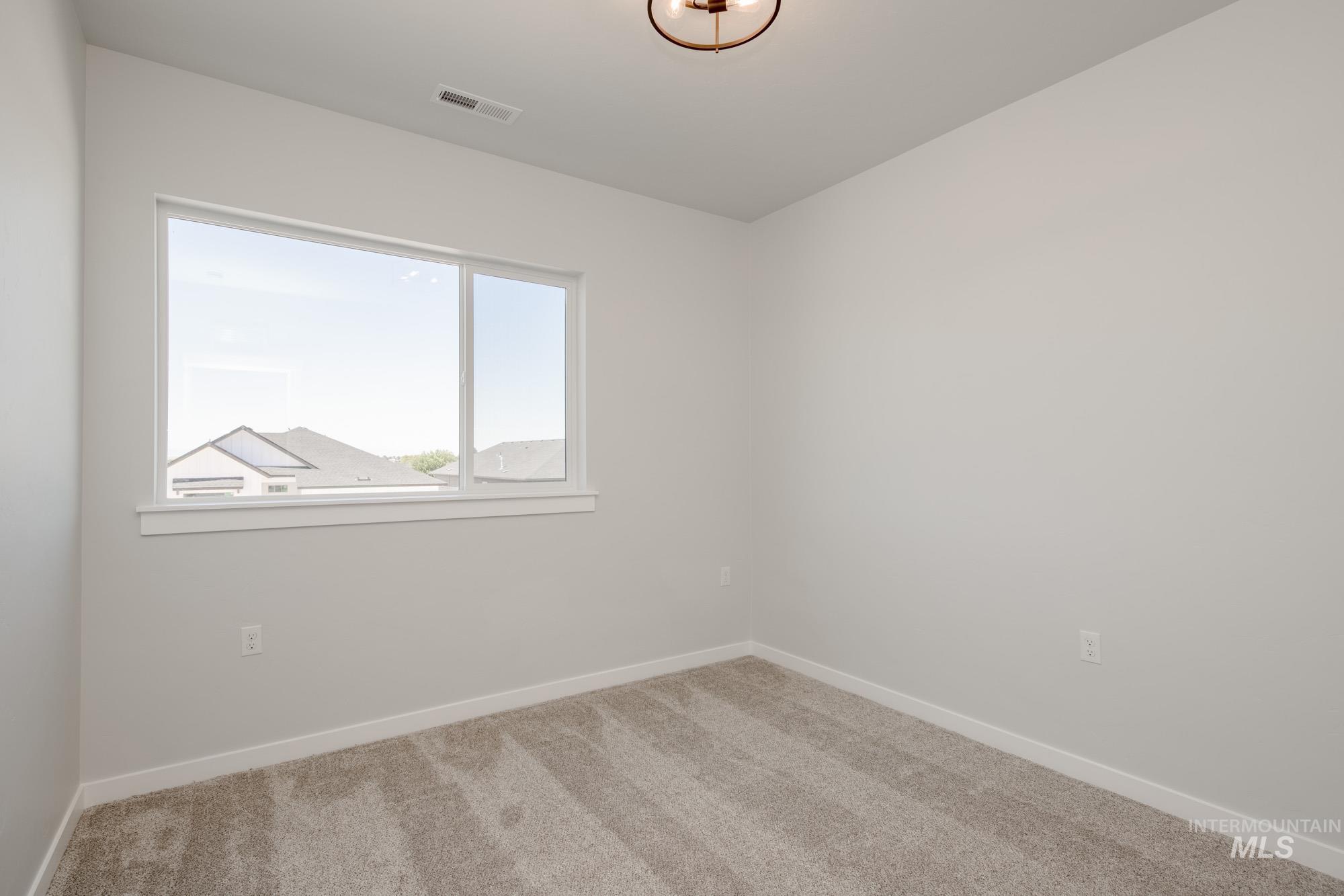 Empty room featuring carpet floors and baseboards