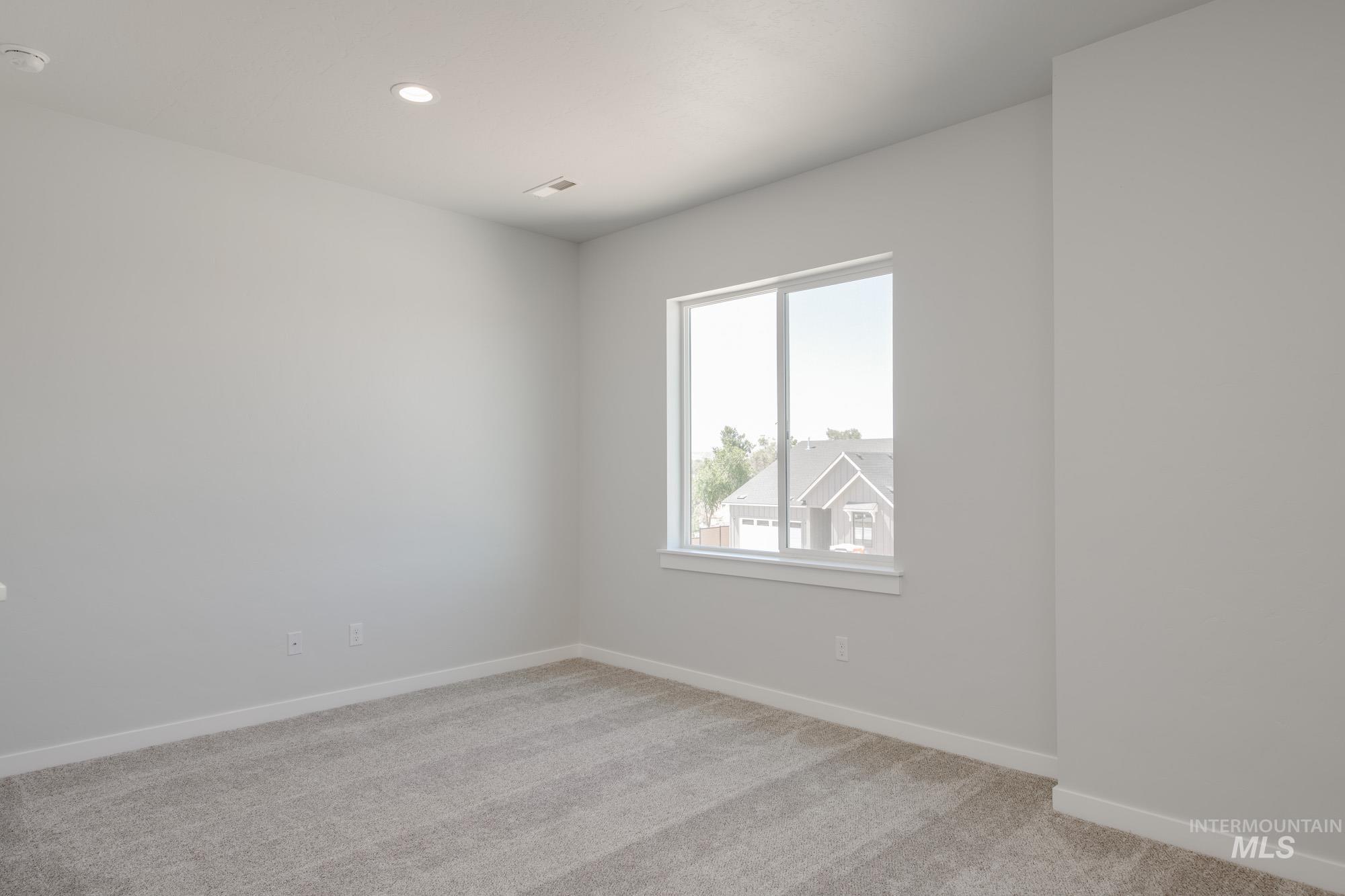 Spare room with light colored carpet, recessed lighting, and a smoke detector