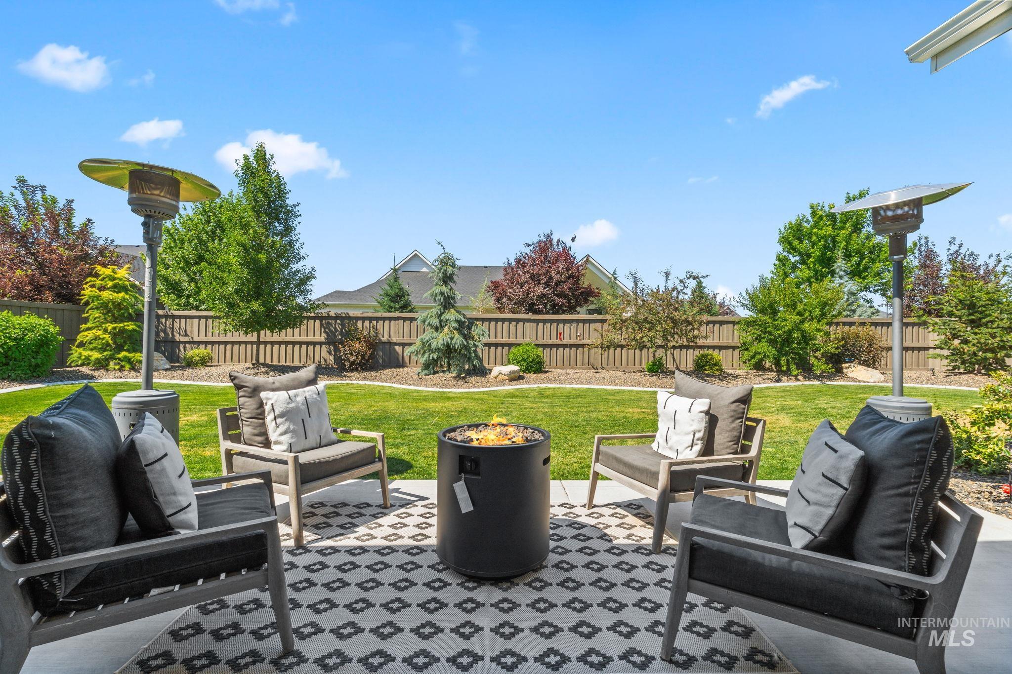 Fenced backyard featuring an outdoor hangout area and a patio