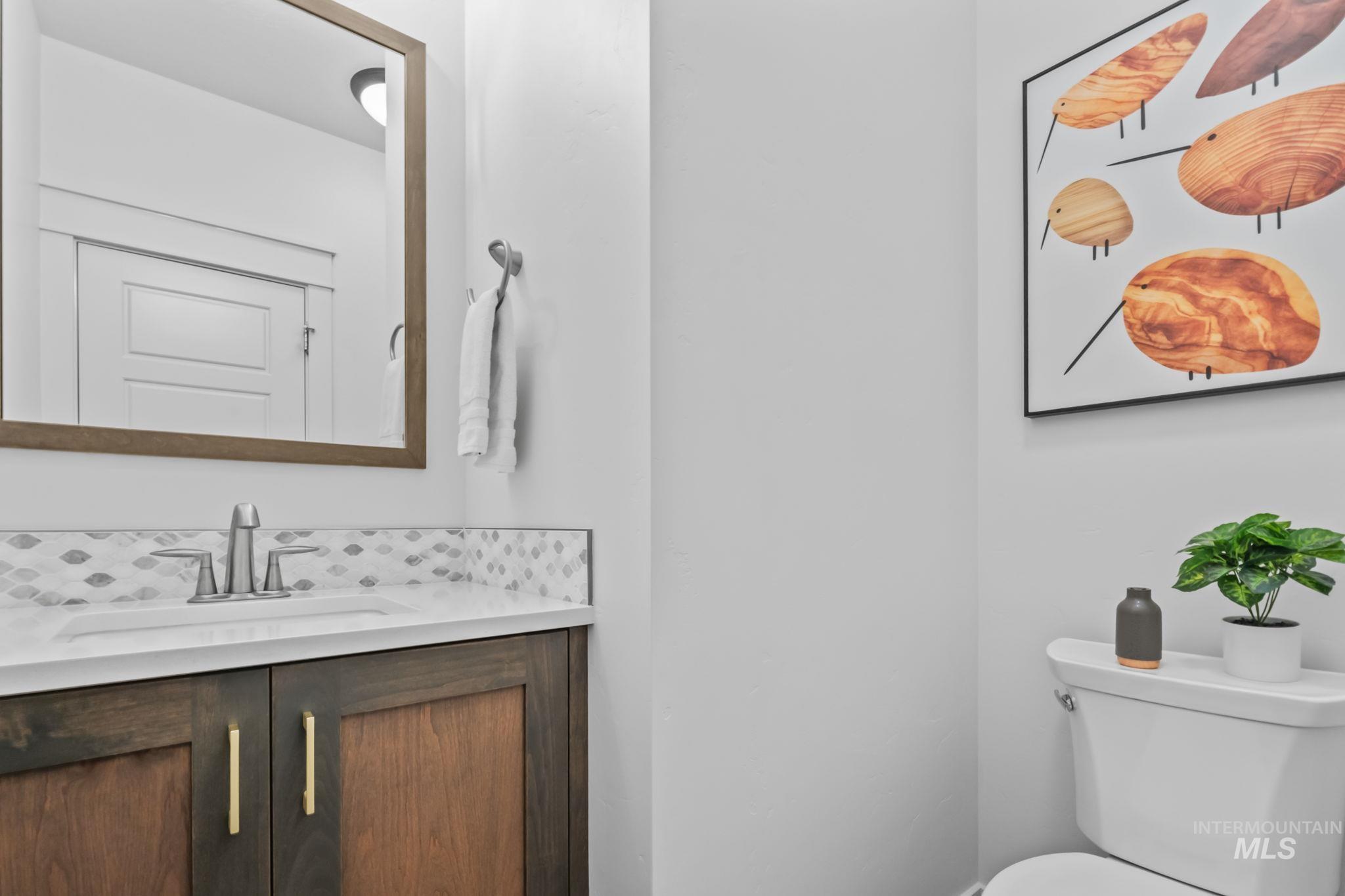 Half bath featuring vanity and toilet