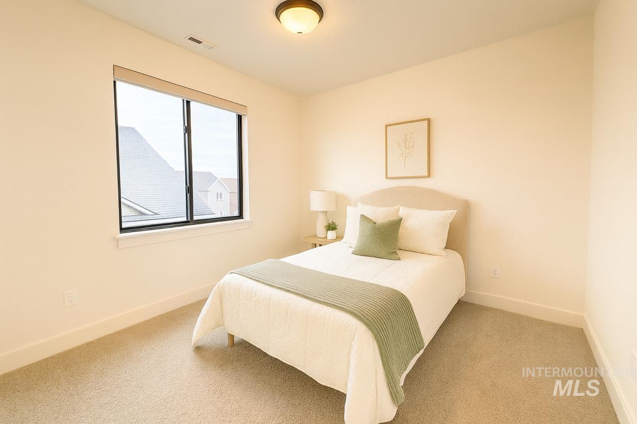 Bedroom featuring carpet floors and baseboards
