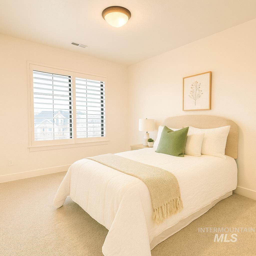 Carpeted bedroom featuring baseboards