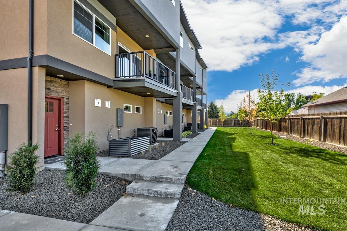 View of home's community featuring a balcony and a fenced backyard