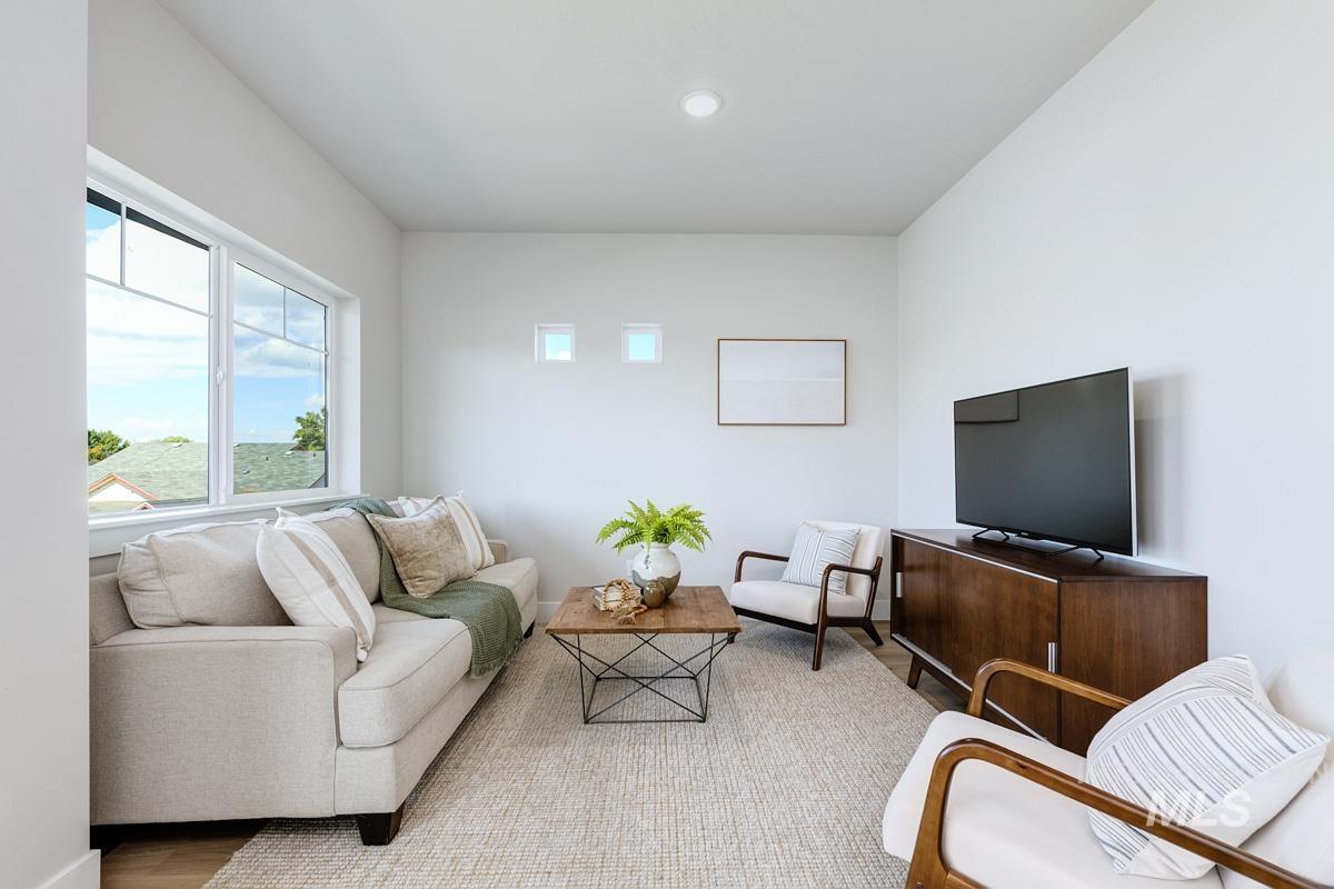 Living room featuring wood finished floors and recessed lighting