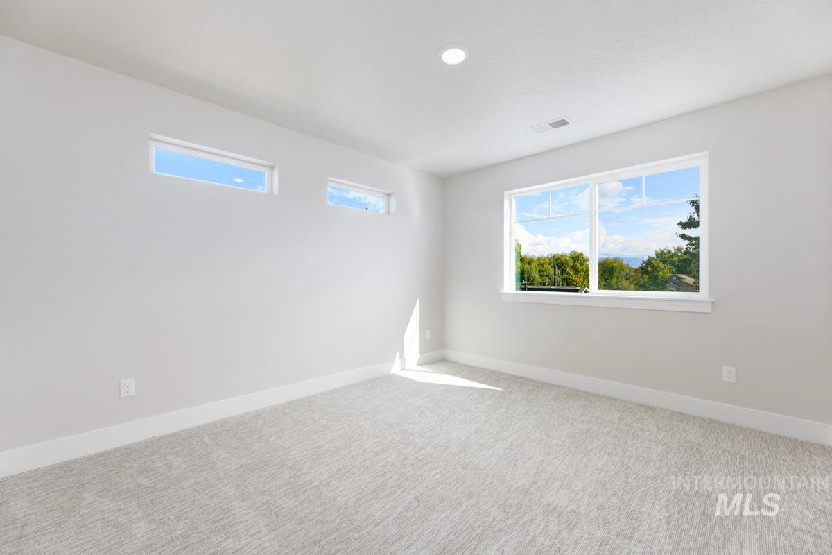 Carpeted empty room featuring baseboards and recessed lighting