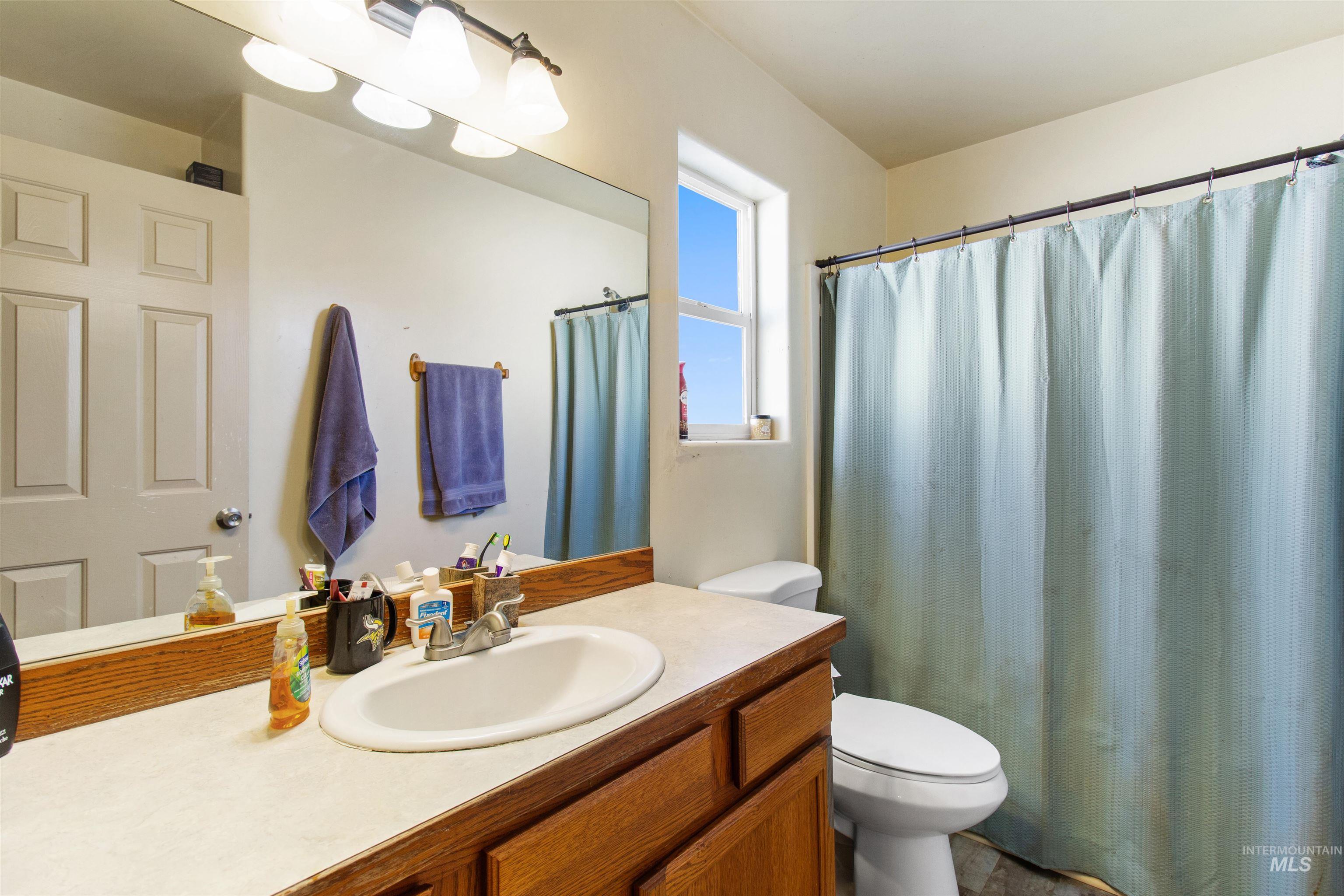 Full bath featuring vanity and a shower with curtain