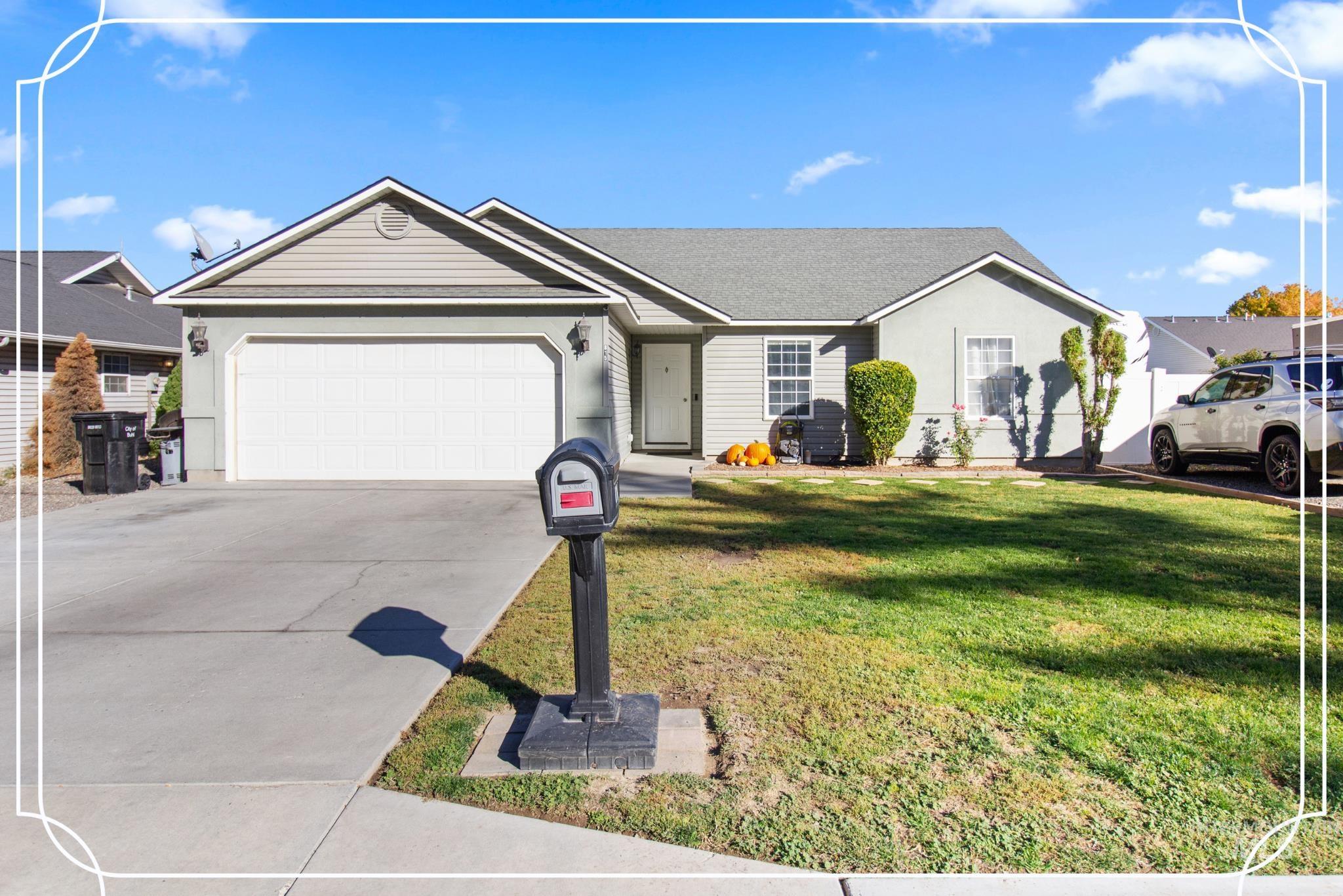 Single story home featuring a front lawn, a garage, and driveway