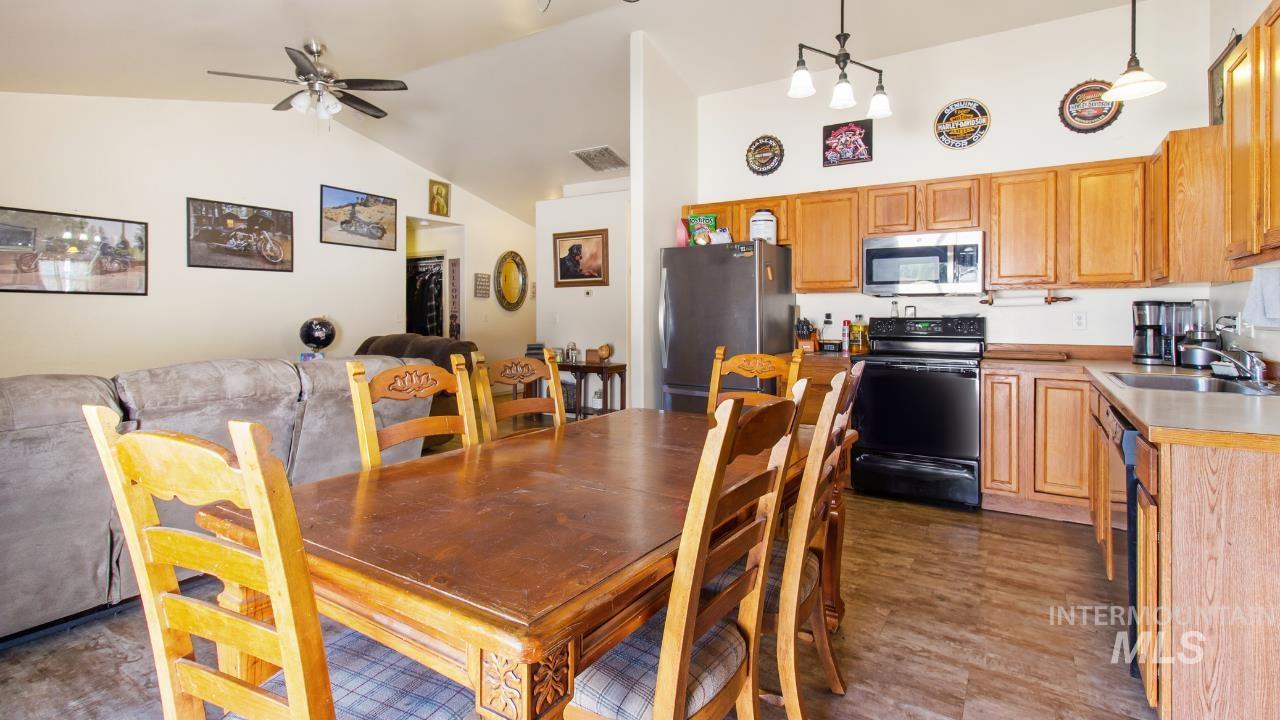 Dining space with vaulted ceiling and a ceiling fan