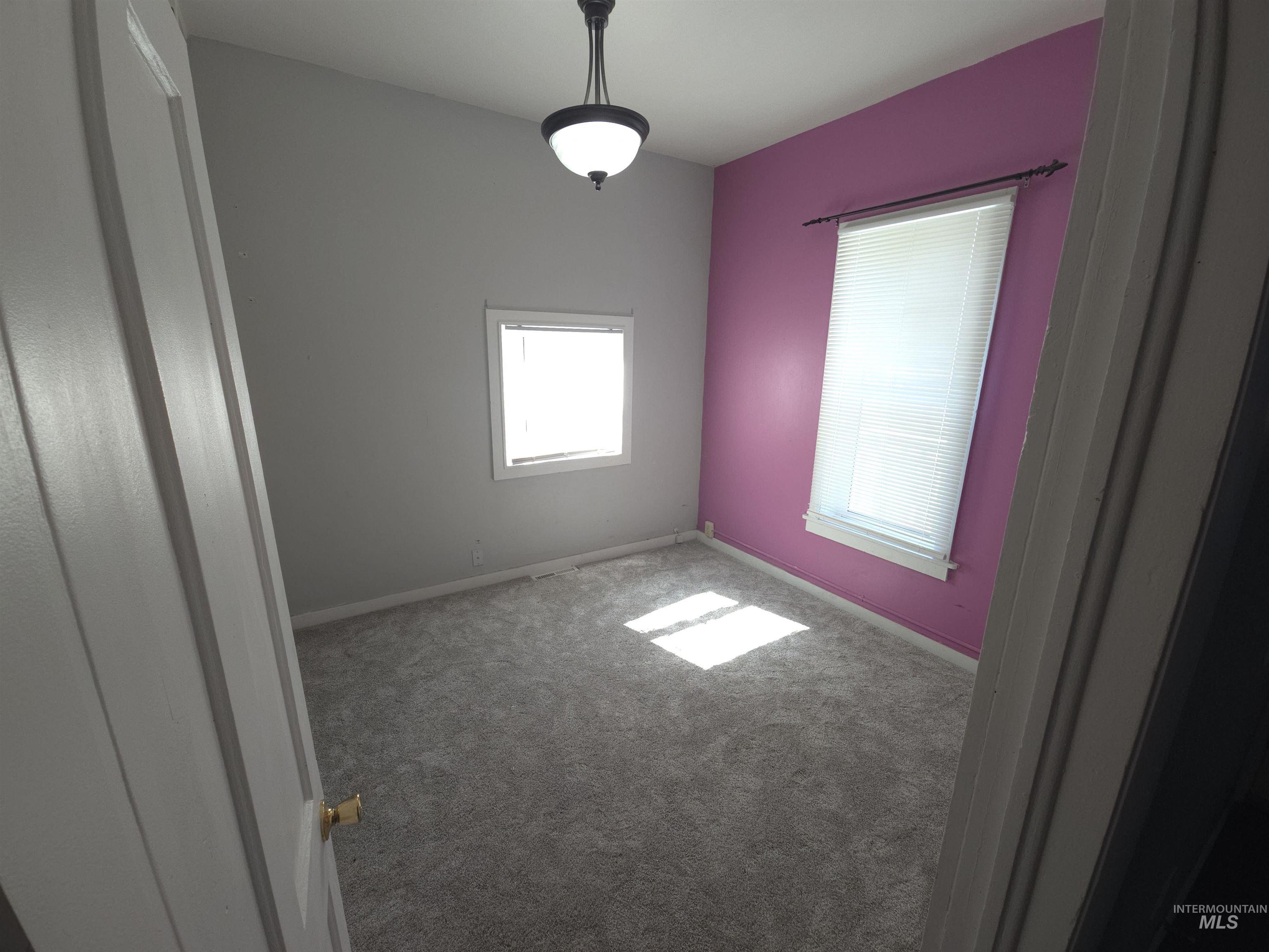 Unfurnished room featuring carpet floors and baseboards