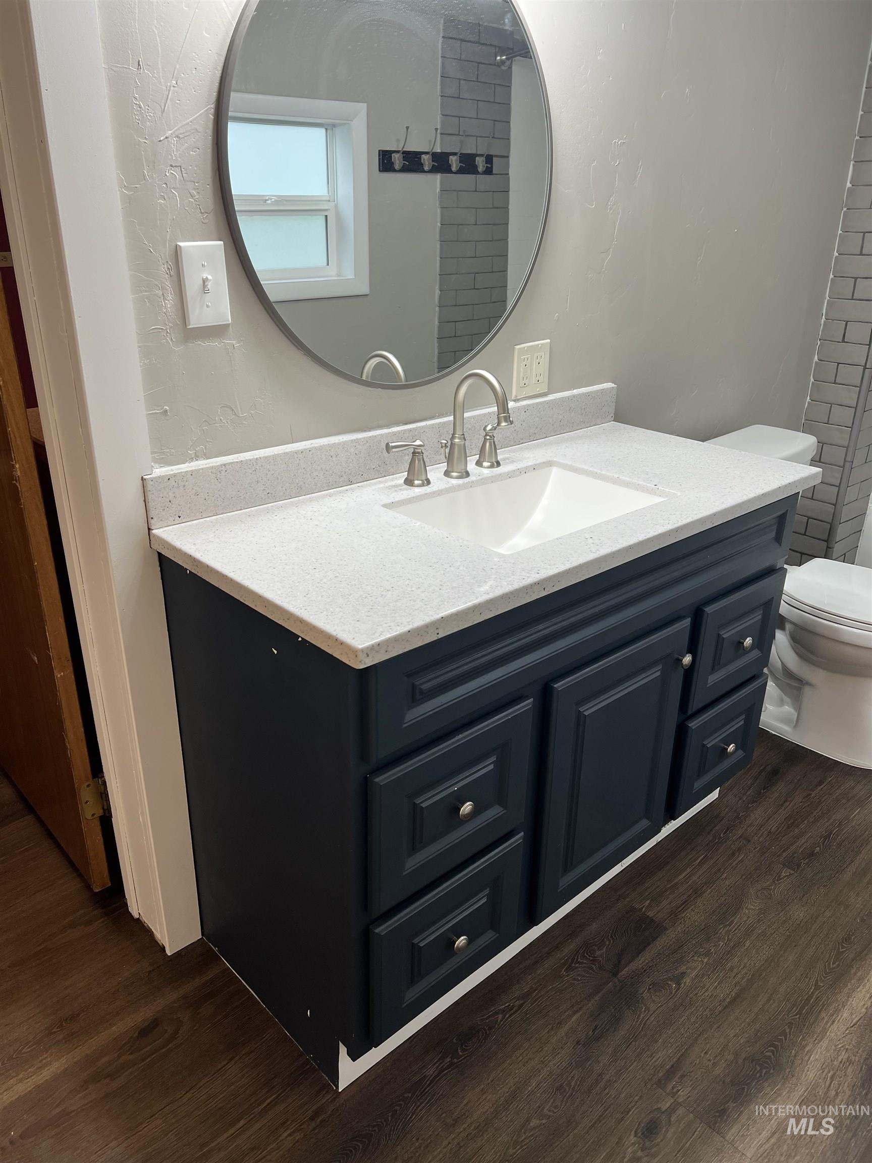 Bathroom with vanity and wood finished floors