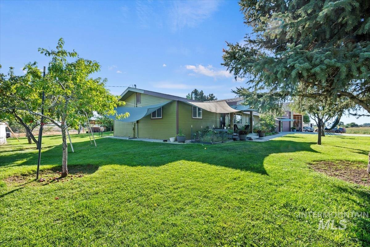 View of home's exterior with a lawn and a patio