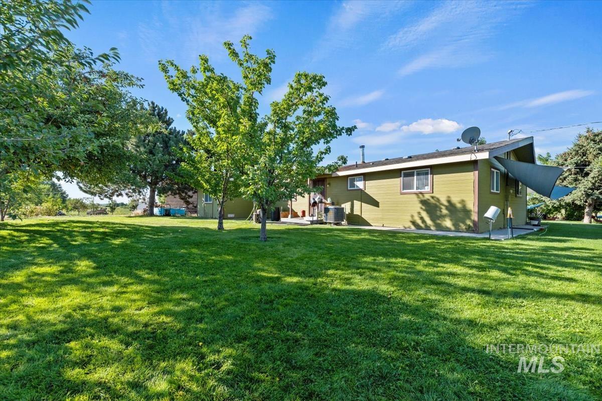 Rear view of house featuring a lawn and a patio