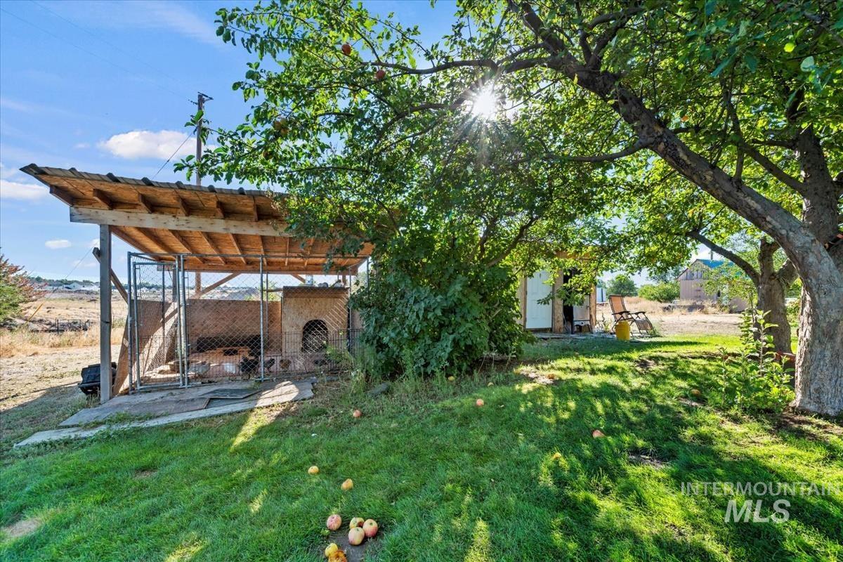 View of green lawn with an exterior structure and an outbuilding