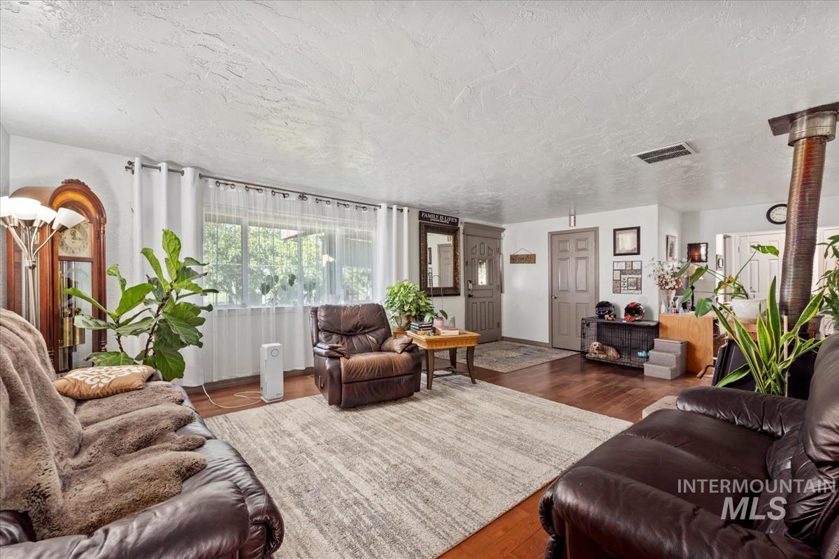 Living area featuring a textured ceiling and wood finished floors