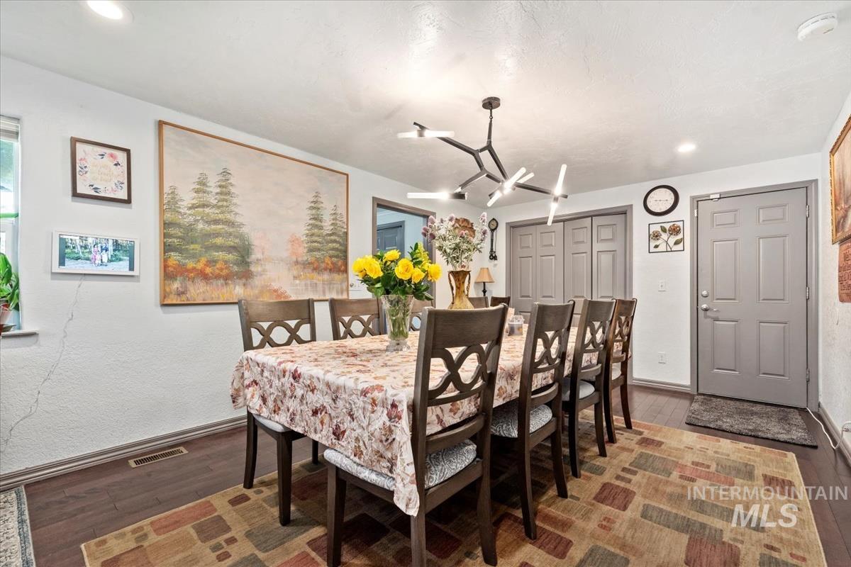Dining room featuring dark wood finished floors and recessed lighting