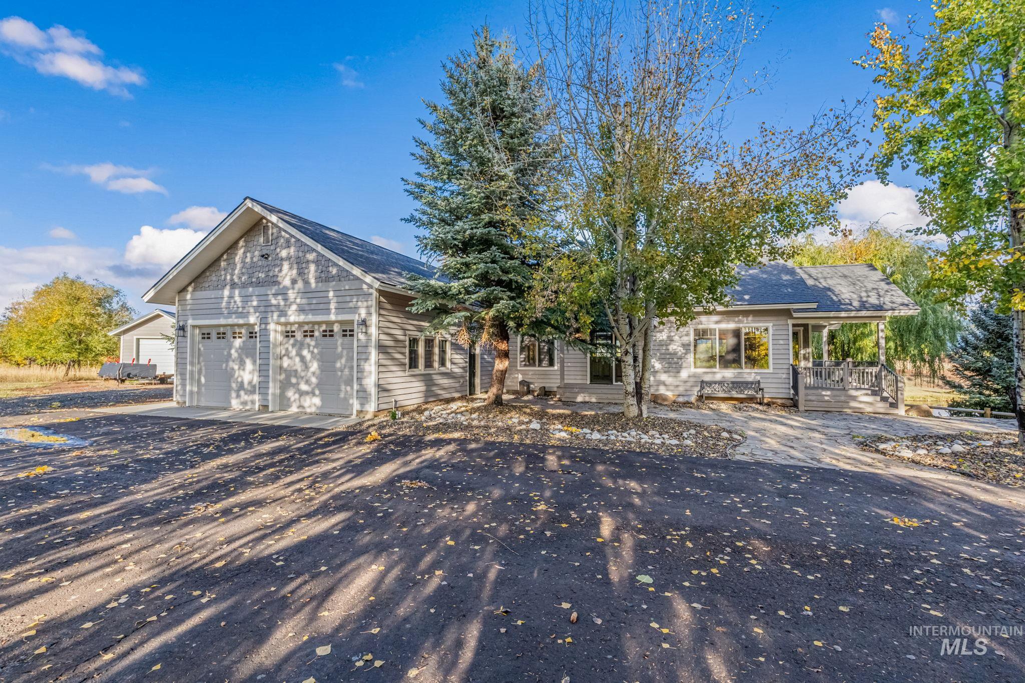 View of front of home with driveway and a garage